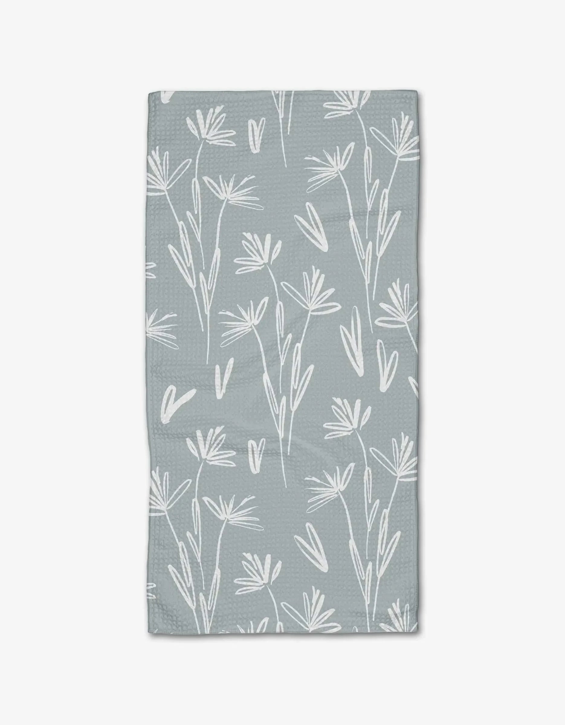 The Sketchbook Floral Bar Towel by Toboggan Avenue features a white, hand-drawn floral and leaf design on light gray Geoweave fabric for enhanced absorbency and durability.