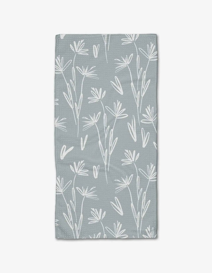 The Sketchbook Floral Bar Towel by Toboggan Avenue features a white, hand-drawn floral and leaf design on light gray Geoweave fabric for enhanced absorbency and durability.