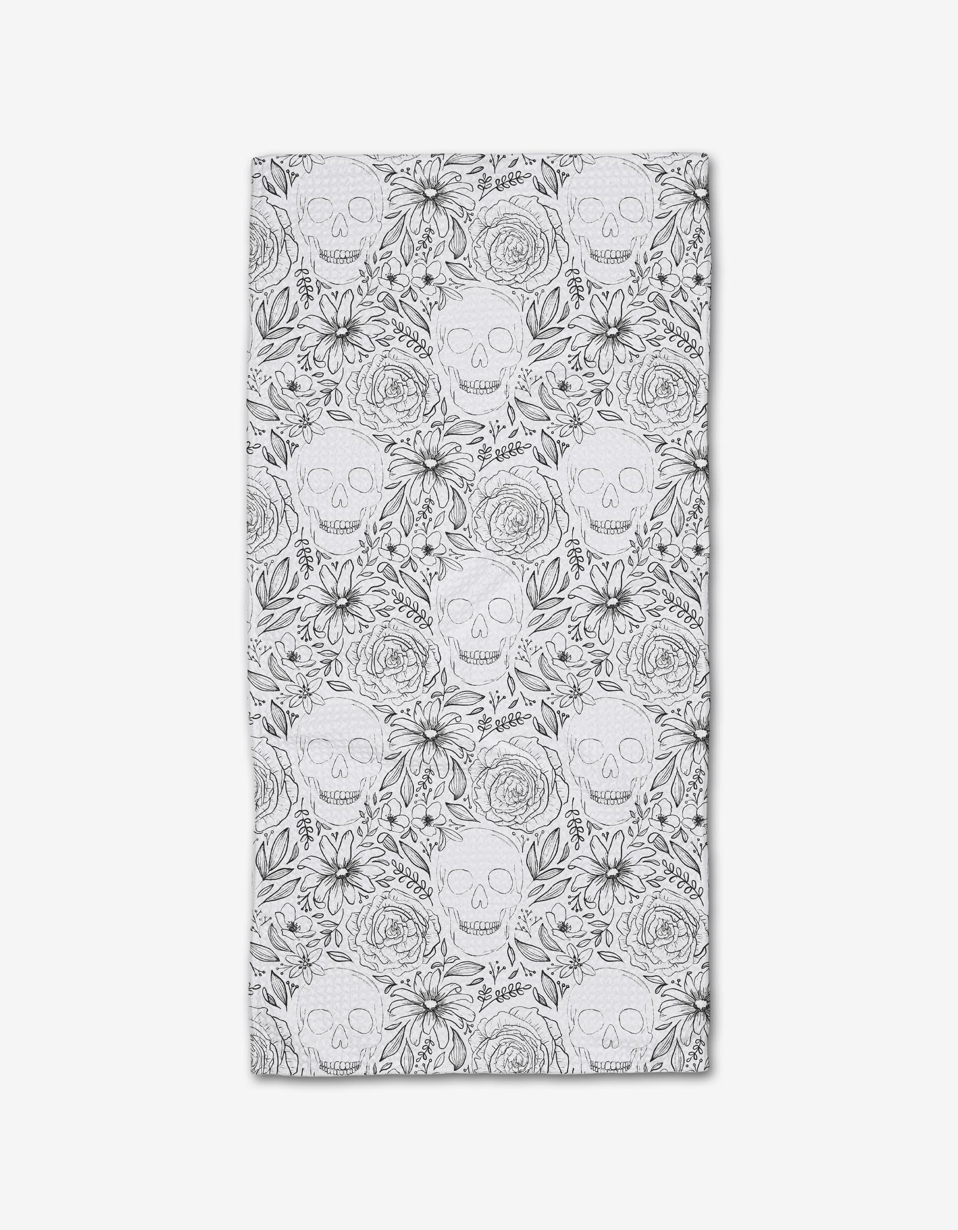 The Skulls and Flowers Bar Towel by Rosa Kichline is a rectangular white towel featuring a black line art pattern of interwoven skulls, roses, and leaves on durable Geoweave fabric for a decorative, detailed look.