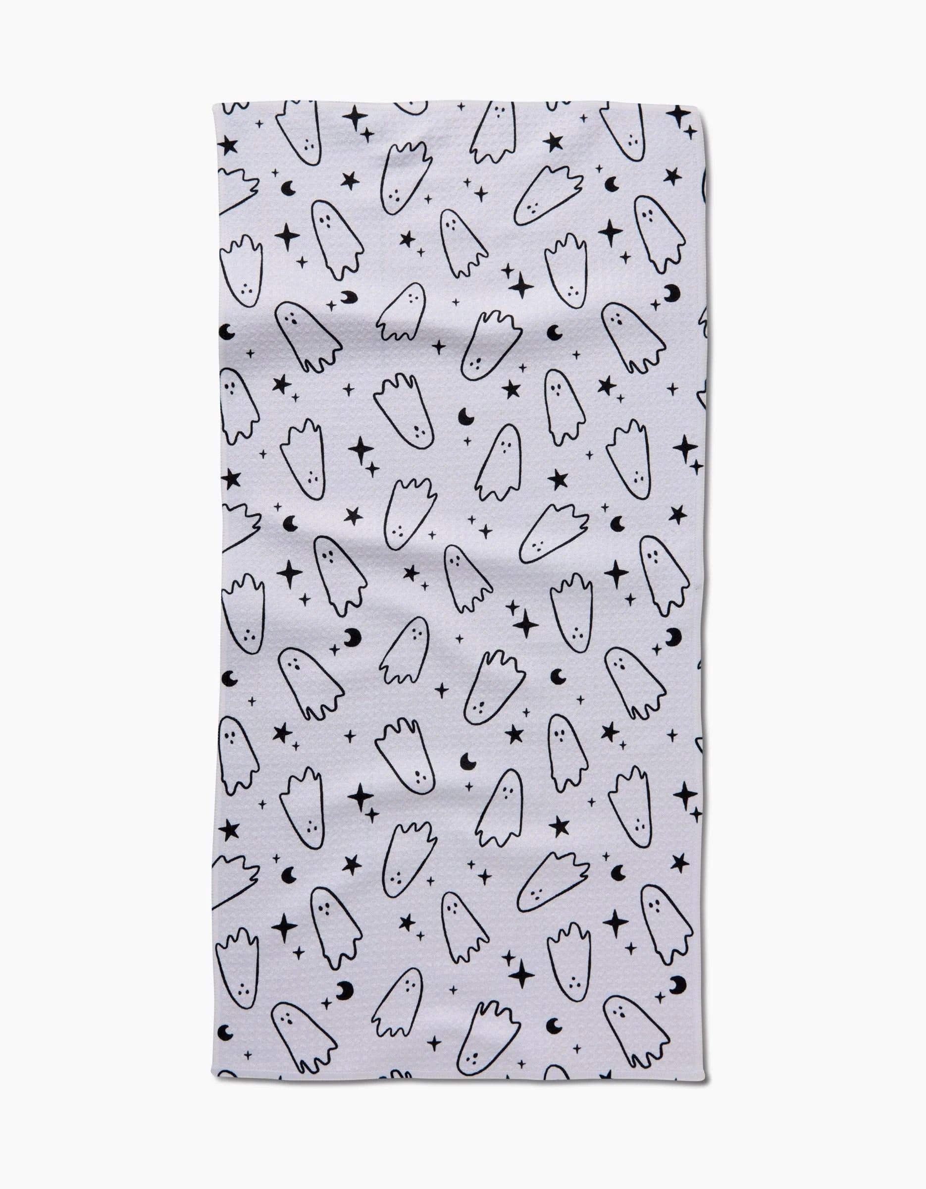 The Space Ghosts Outline towel by Hufton Studio is a white, ultra-absorbent rectangle featuring a repeating pattern of simple cartoon ghost outlines and scattered small black stars.