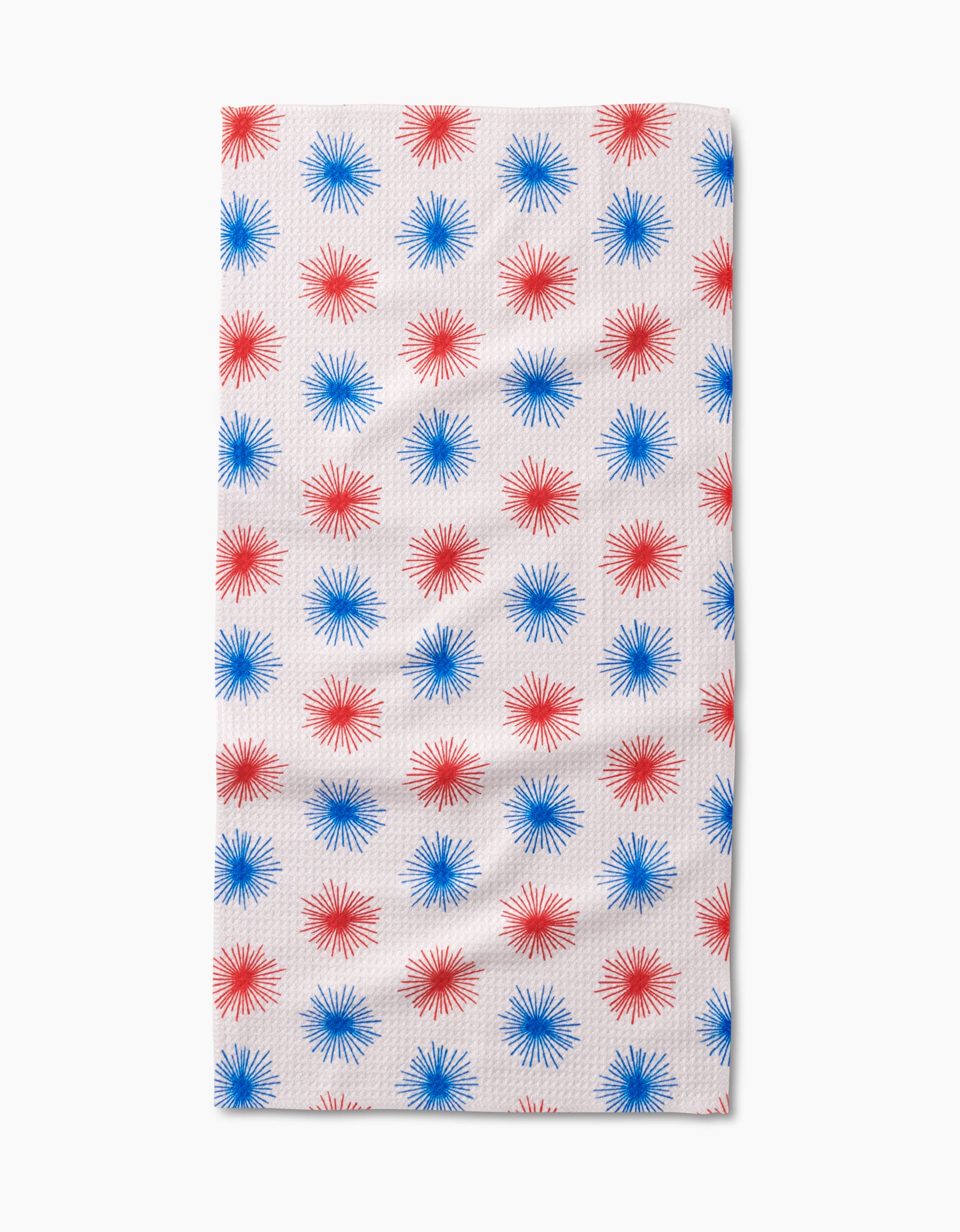 The Kayla Ann Sparkler Splash Bar Towel features a rectangular white Geoweave fabric with rows of evenly spaced red and blue starbursts for stylish, durable flair.