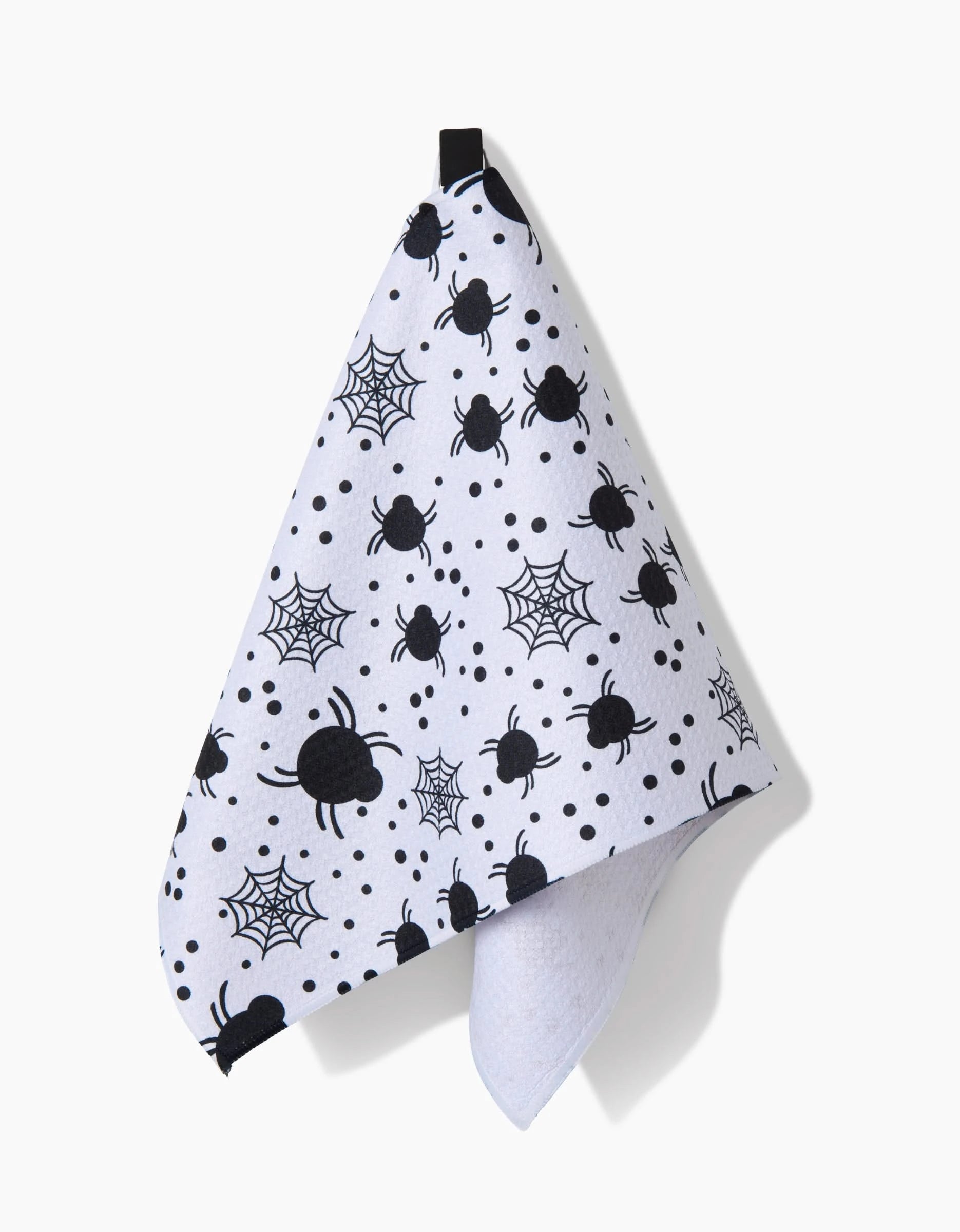The Spiders For Days towel by Charlie Rowan Designs is an ultra-absorbent white towel featuring black spiders, webs, and dot patterns, shown hanging from a black loop against a white background.