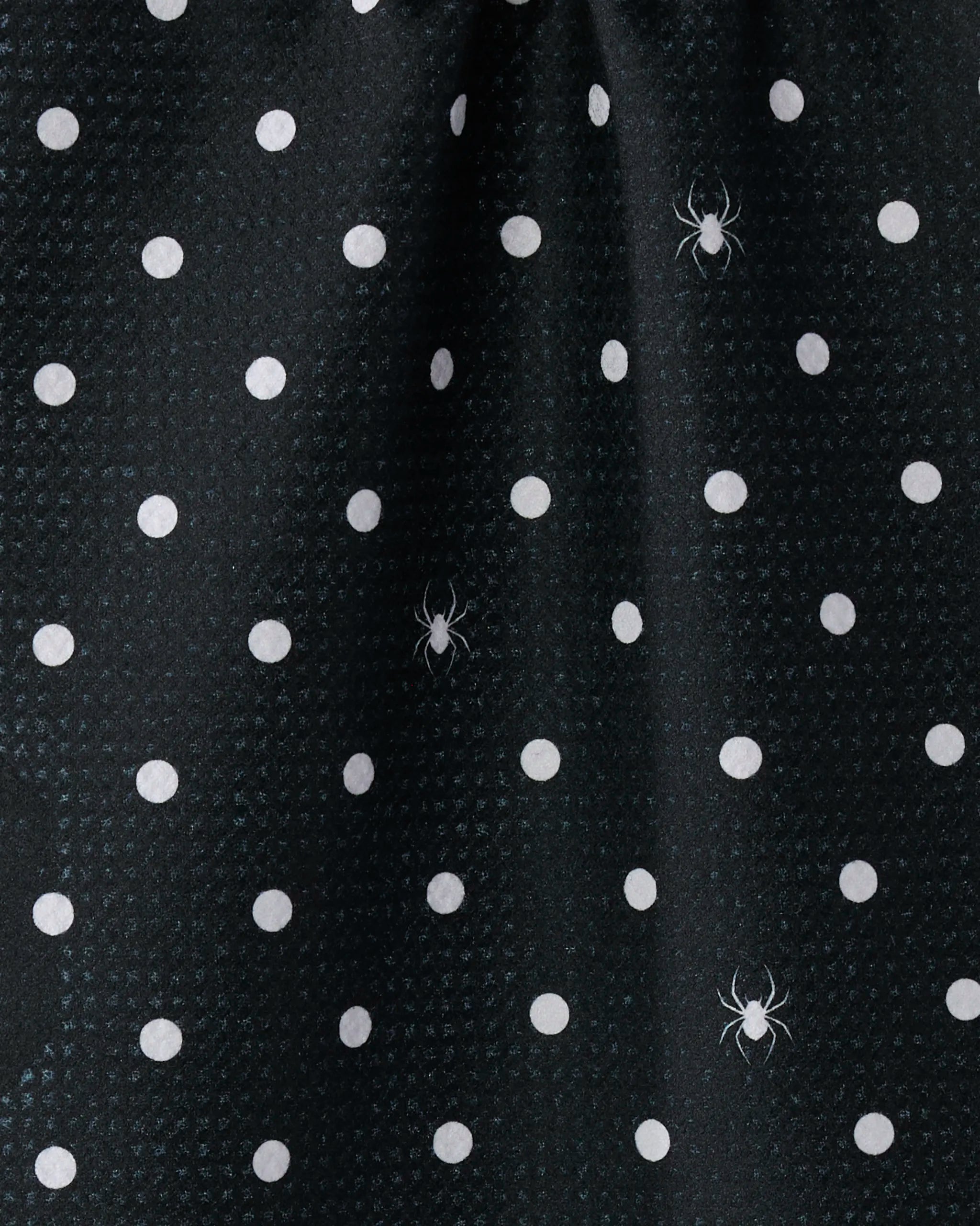 The Geometry Spookydots bar towel features black fabric with evenly spaced white polka dots and scattered white-printed spider illustrations, adding a subtle spooky touch. Made from recycled materials.