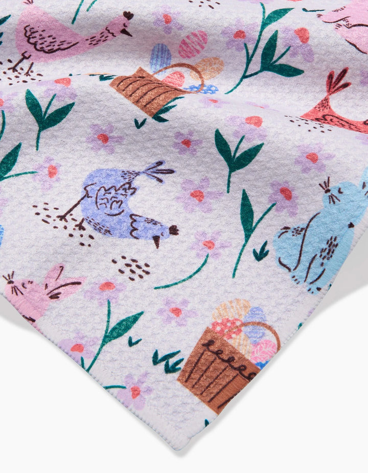 The Spring Bunnies towel by Charlie Rowan Designs features pastel patterns with chickens, bunnies, Easter egg baskets, and green leafy plants on a light background. Ultra-absorbent and perfect for springtime celebrations.