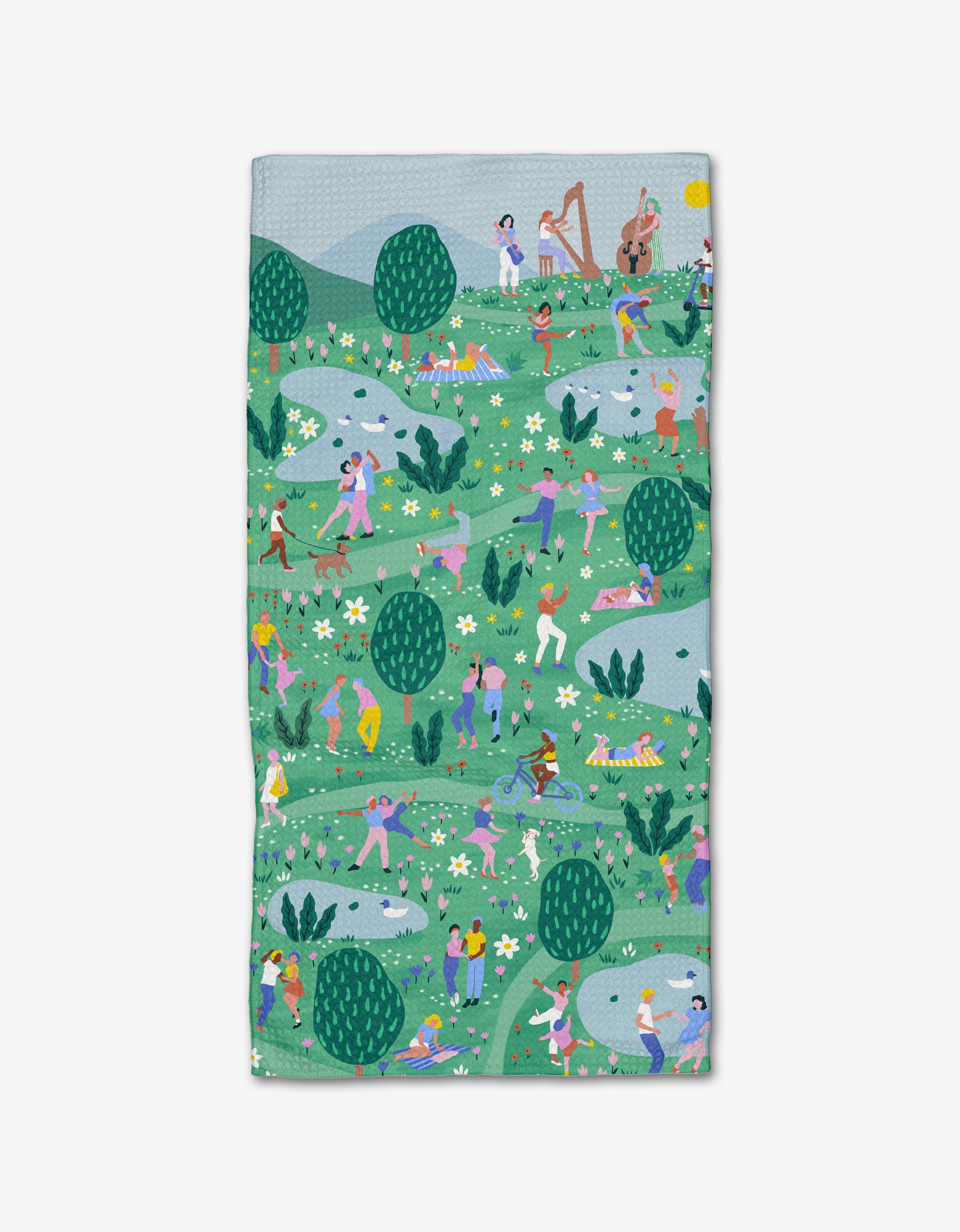The Spring Festival bar towel by Ceyda Alasar is made from recycled materials and features lively illustrations of people dancing, playing music, and relaxing in a vibrant green park.