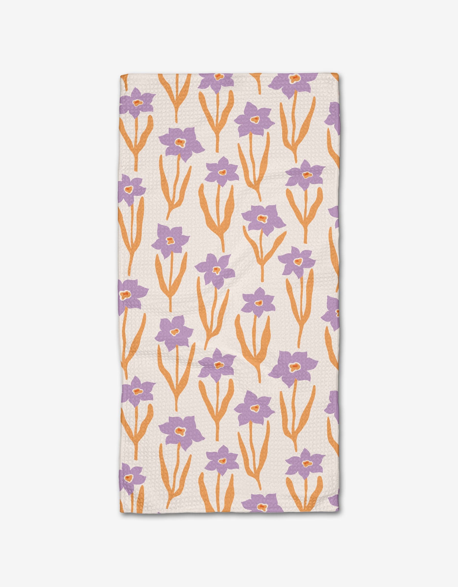 The Spring napkin by Kayla Ann is a rectangular Geoweave cloth featuring orange stems and leaves with purple flowers on a white background.