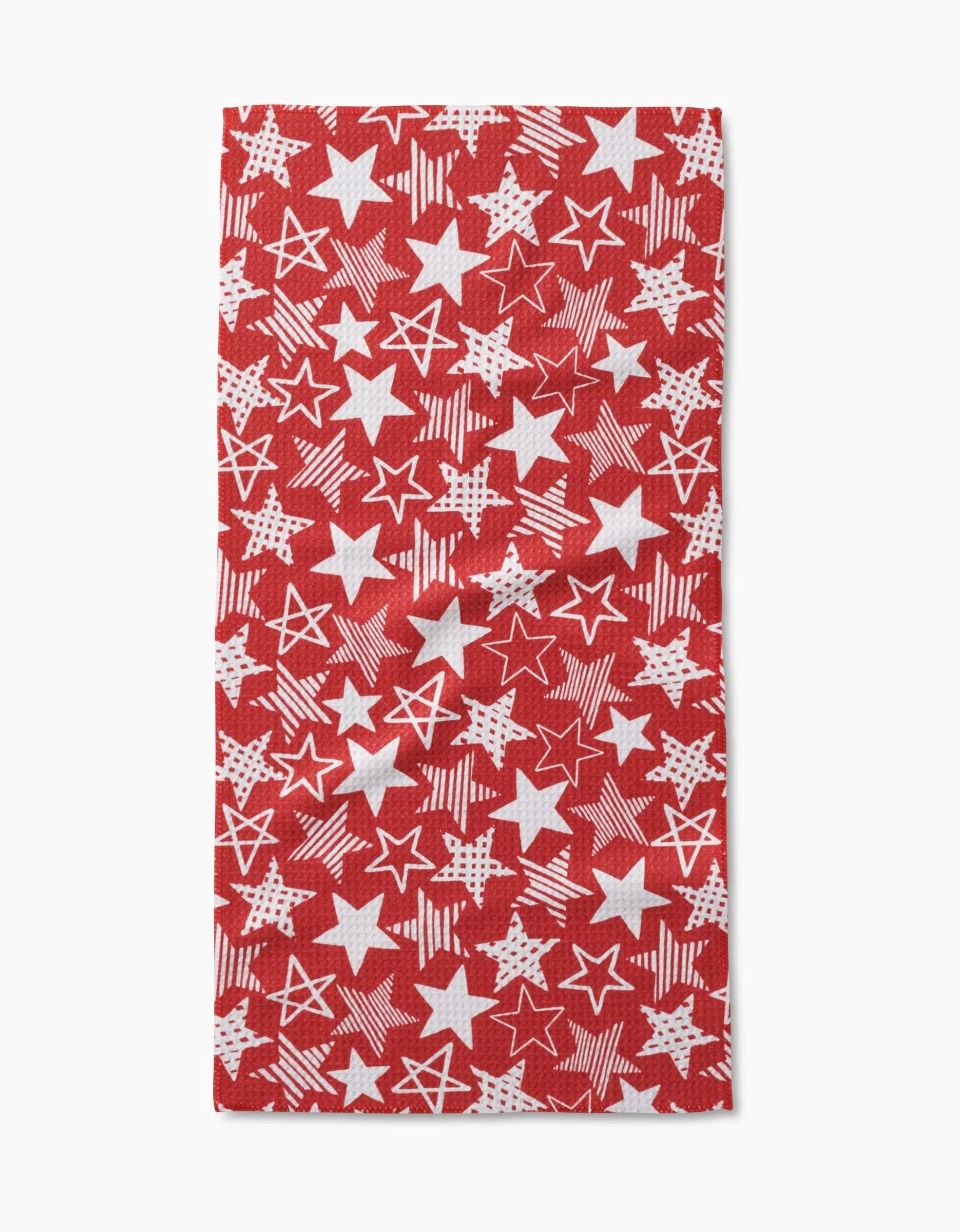 Stars In Your Eyes Red by Hufton Studio is a red rectangular bar towel with a pattern of solid, outlined, and textured white stars. Made from Geoweave fabric for excellent absorbency and quick drying.