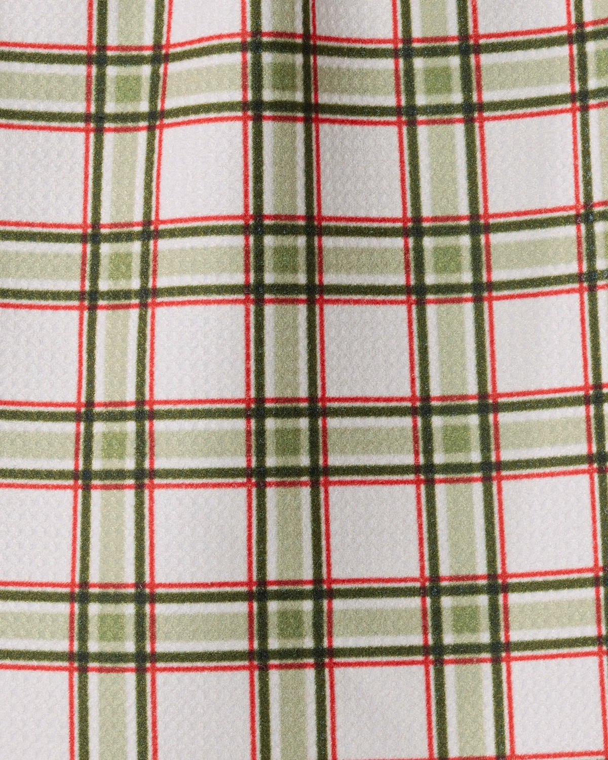 Introducing the Stocking Plaid mini towel by Geometry, crafted from recycled materials for a sustainable touch. This stylish mini towel features white Geoweave fabric with a crisp, subtly textured finish and an evenly spaced plaid pattern of intersecting green and red lines that form neat squares. Perfectly combining eco-conscious design with festive flair.