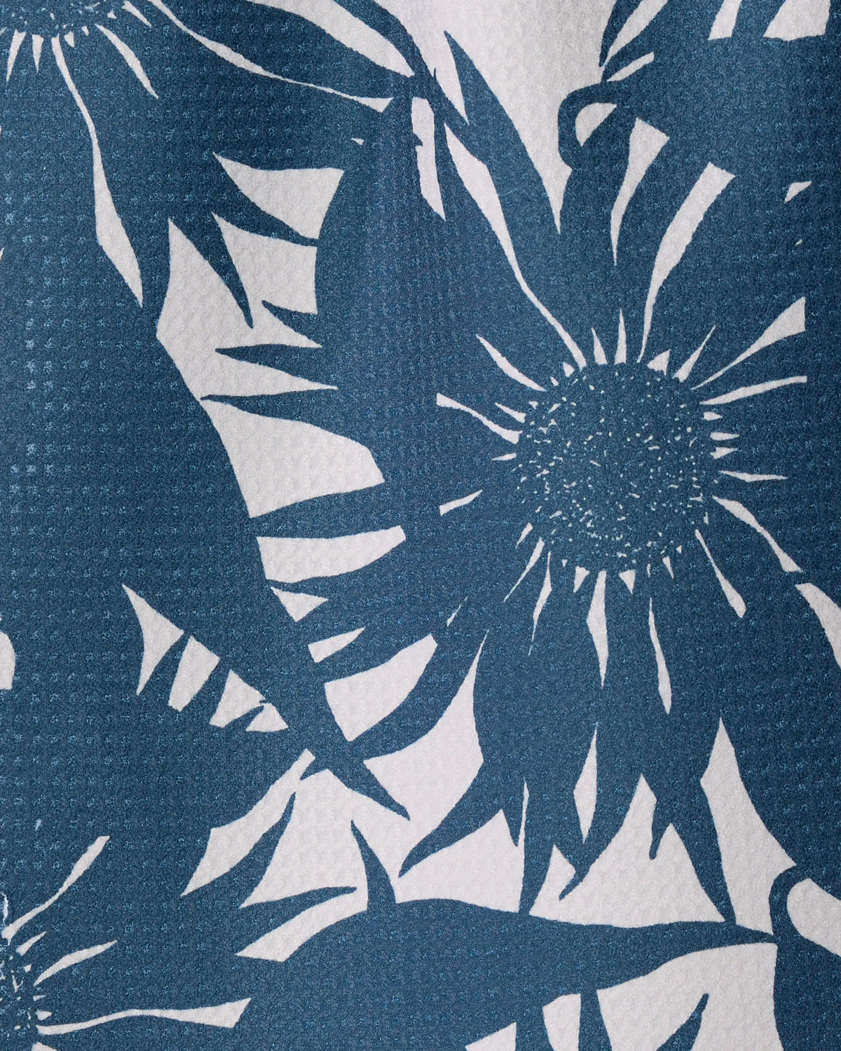 Sundara Silhouette Frost by Geometry features a blue and white floral pattern with large, abstract flowers and pointed petals on a textured geoweave fabric surface, expertly crafted from recycled materials.