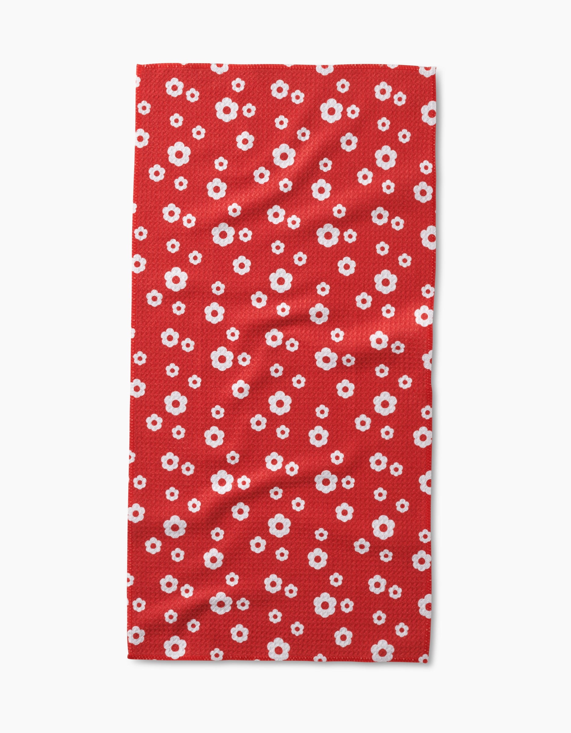 The Sunny Flowers rectangular bar towel by Danelys Sidron is made from recycled materials and features small white and pink daisy-like flowers evenly spread on a solid red background.