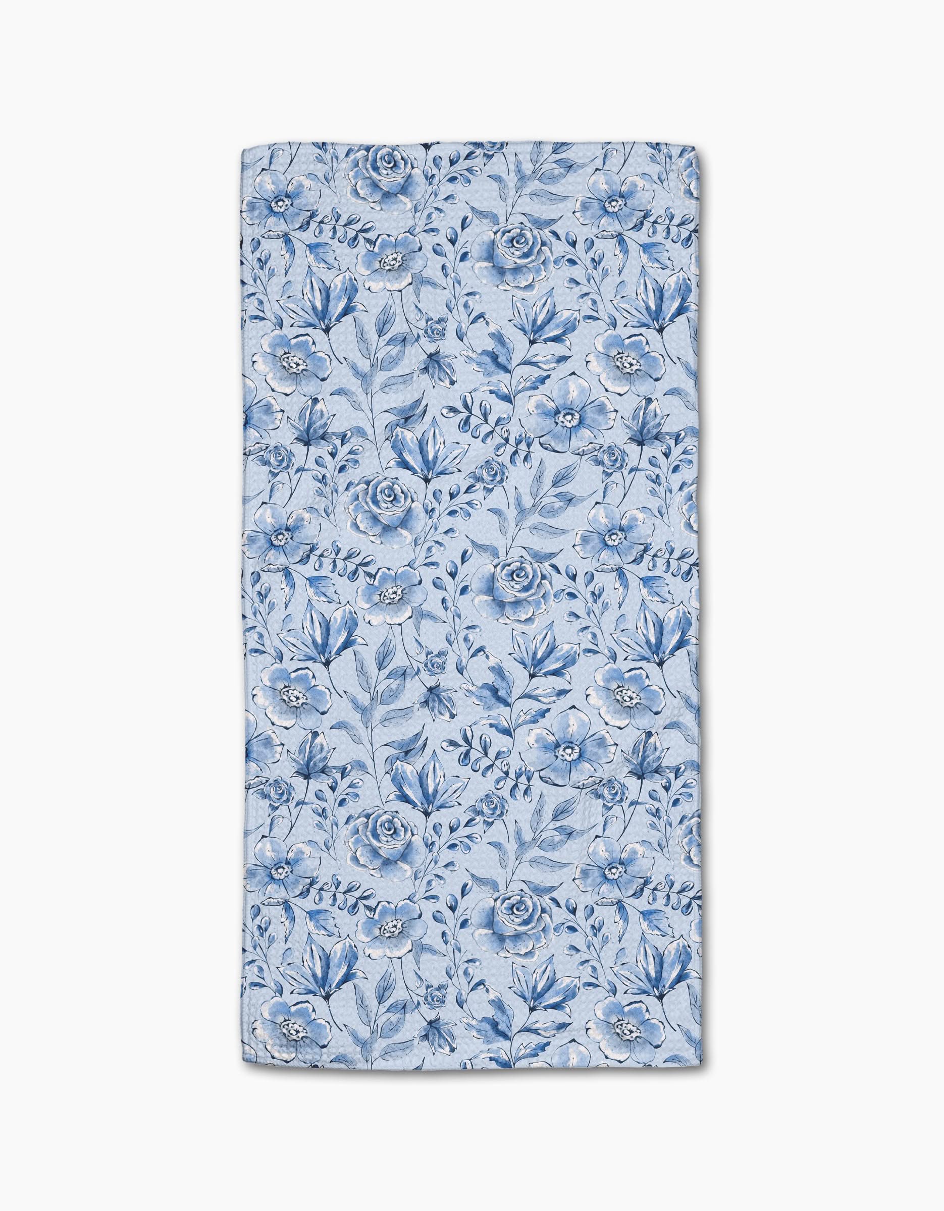 The Sara Mari Tea Set Blossoms bar towel features a blue floral pattern with various flowers and leaves on a light blue Geoweave fabric, shown flat against a white background.