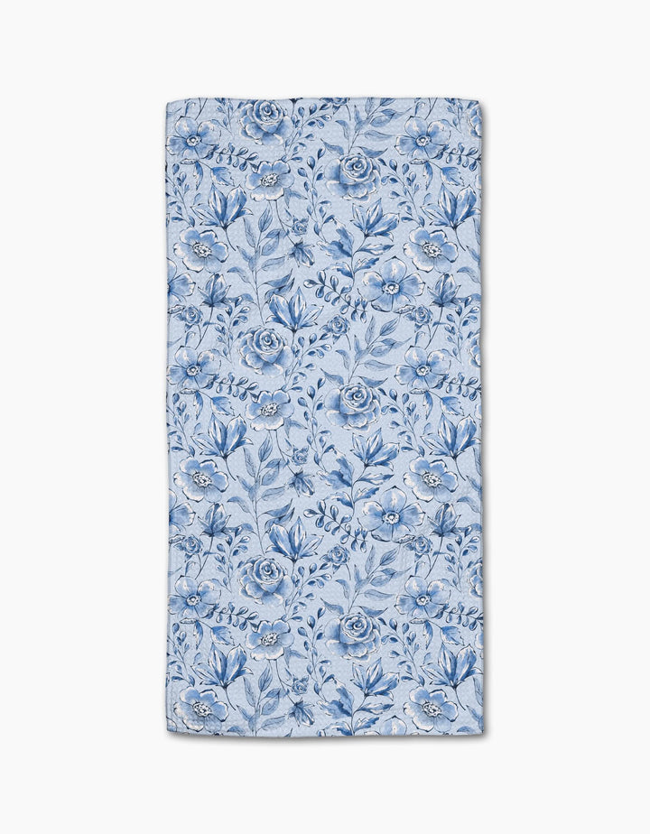 The Sara Mari Tea Set Blossoms bar towel features a blue floral pattern with various flowers and leaves on a light blue Geoweave fabric, shown flat against a white background.