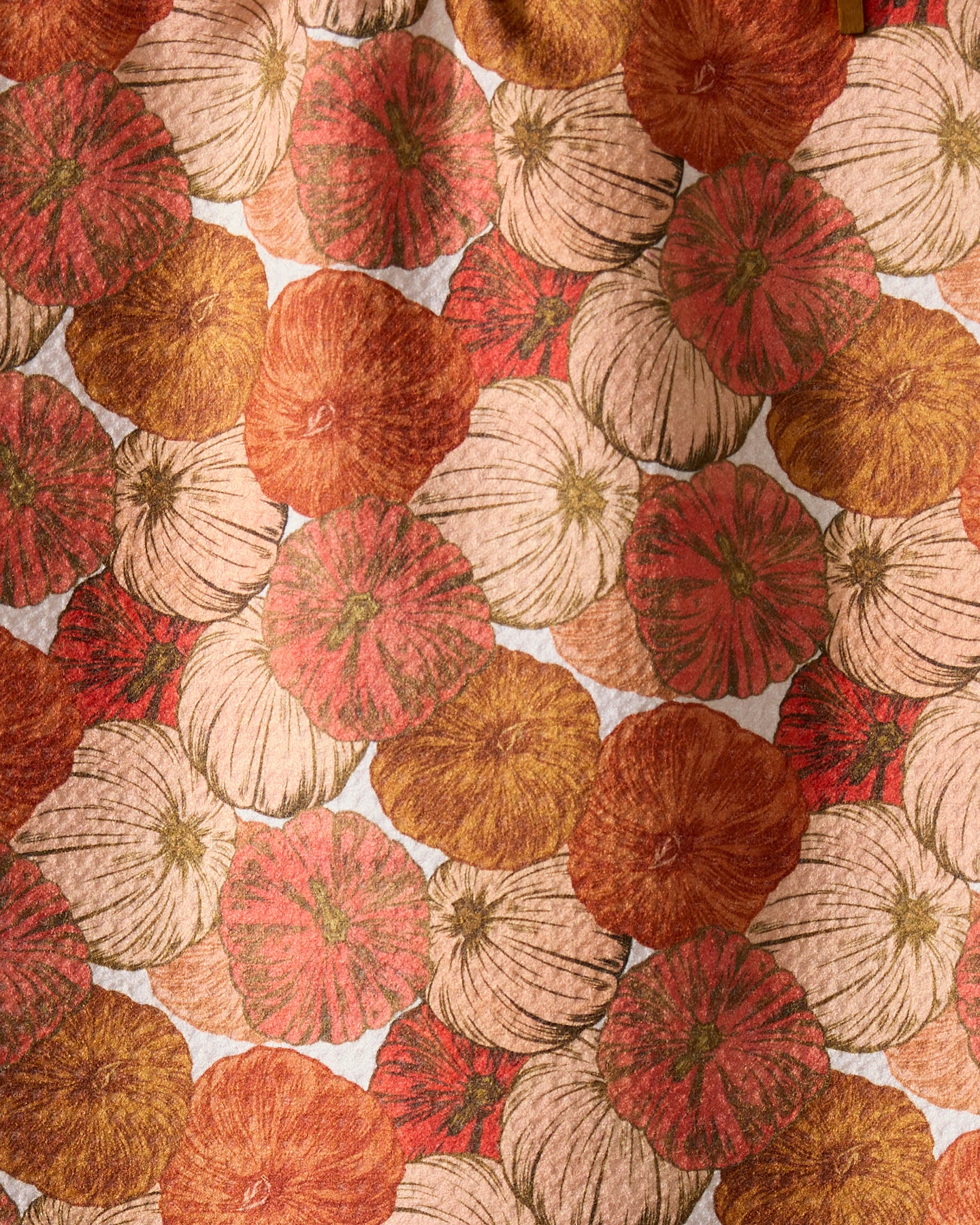 Geometry’s Tendril towel features a harvest-inspired pattern of overlapping orange, cream, and brown pumpkins with textured lines, creating an autumn look thats perfect for this ultra-absorbent towel.
