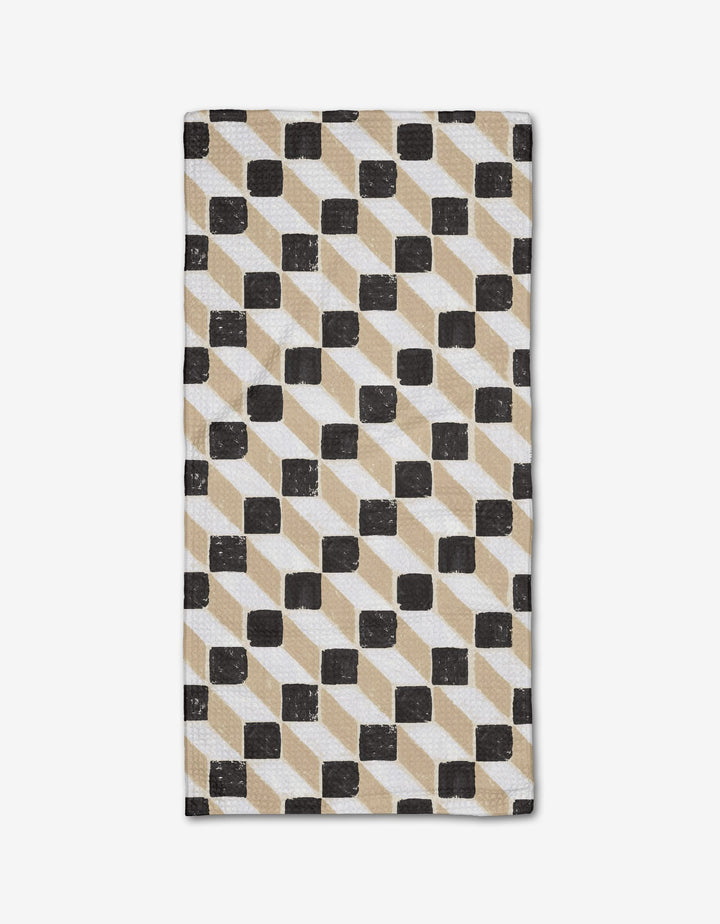 The Tessera Bar Towel by Studio Jeannot showcases a geometric pattern of black, beige, and white parallelograms and squares on a white background, made from recycled materials.