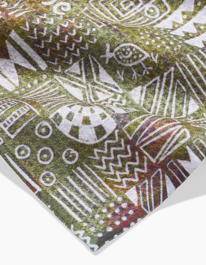 The Taryn Brennan Tribal Symbols Bar Towel showcases white geometric and tribal patterns—including zigzags, circles, and an eye—on a green and brown Geoweave fabric, offering an eco-friendly touch for your bar.