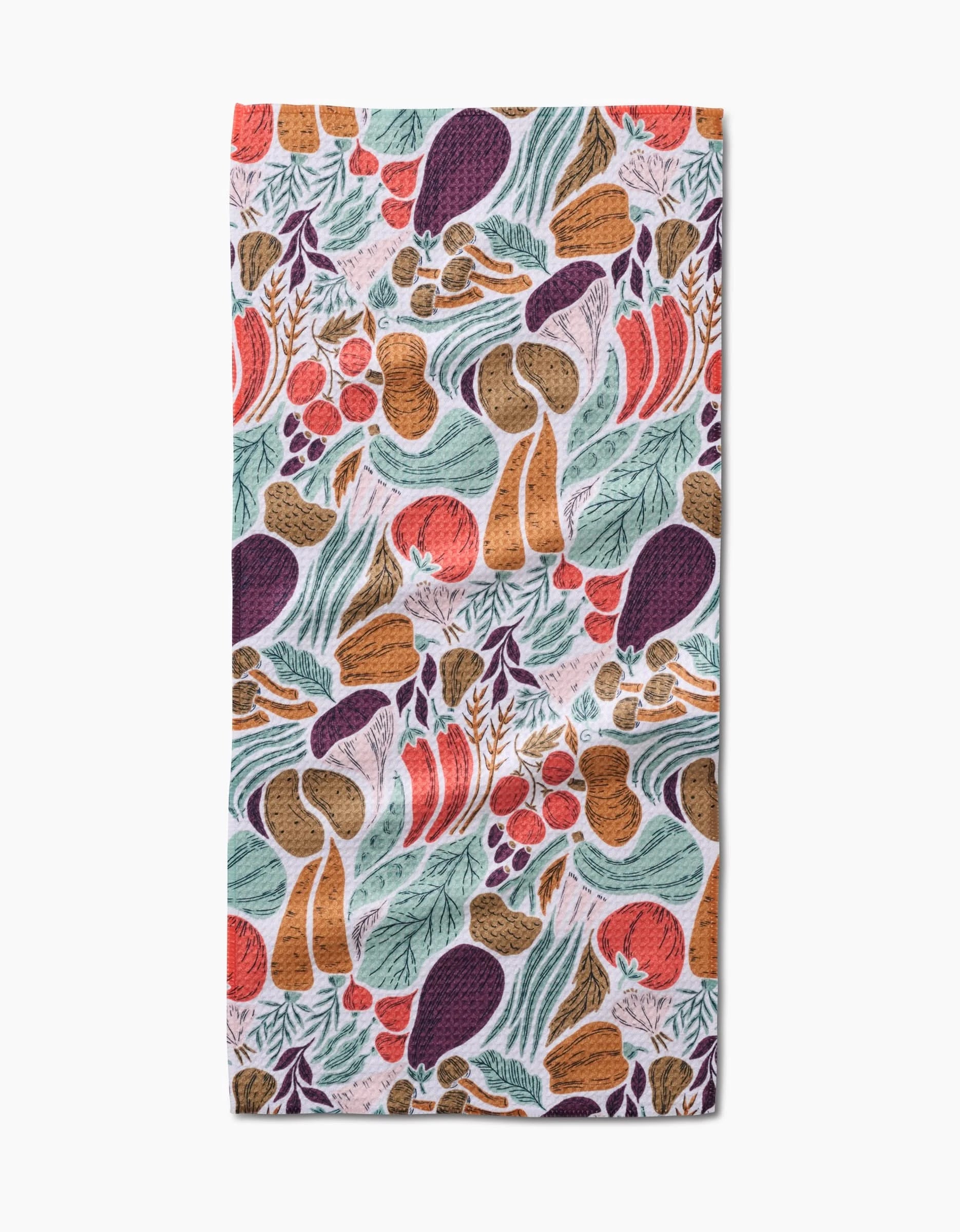 The Twila Bar Towel by Amy MacCready features a colorful hand-drawn mushroom and foliage pattern in orange, purple, red, green, and brown on white Geoweave fabric.