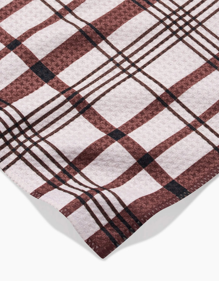 A close-up of Hufton Studios Vintage Plaid Natural bar towel, featuring soft, textured recycled fabric in a red, white, and black pattern against a white background.