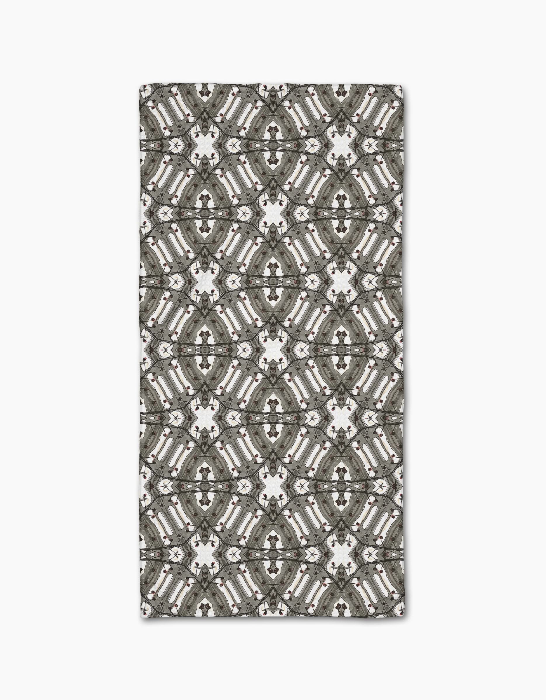 The Walk The Line Shimmy rug by Katherine Berkeley features repeating geometric diamond and circular patterns in gray, white, and black, covering the surface, and is crafted from recycled materials.