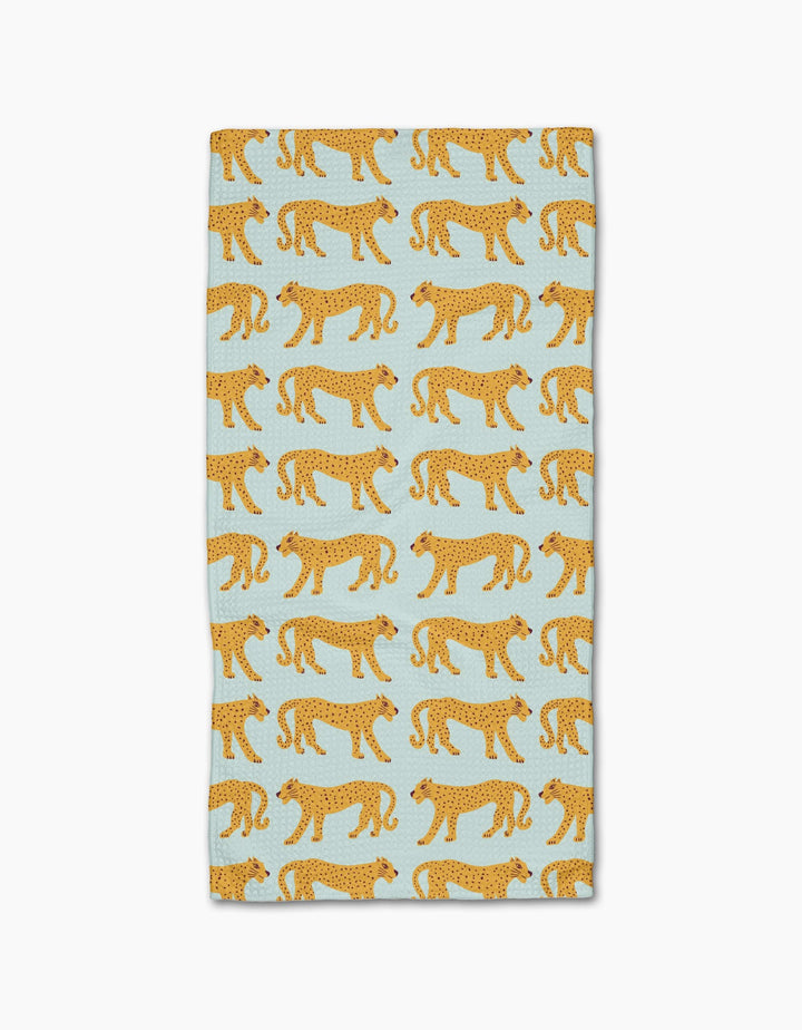 The Walking Cheetah bar towel by Jasmine Blooms Designs features a light blue rectangle with rows of orange, black-spotted cheetahs and is made from ultra-absorbent recycled materials for style and sustainability.