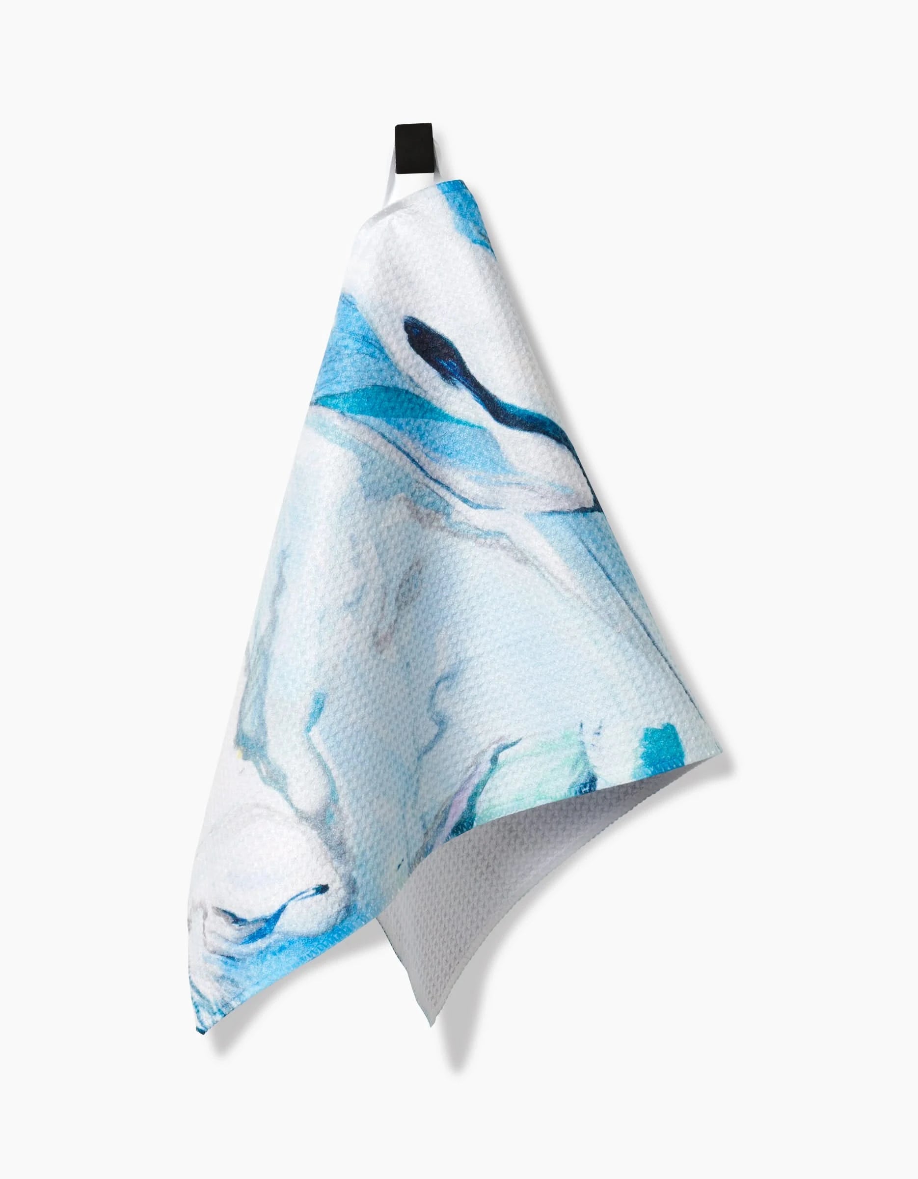 The Where He Laid To Go bar towel by Kelly Peters, crafted from recycled materials with a blue and white abstract swirl design, hangs from a black loop against a plain white background.