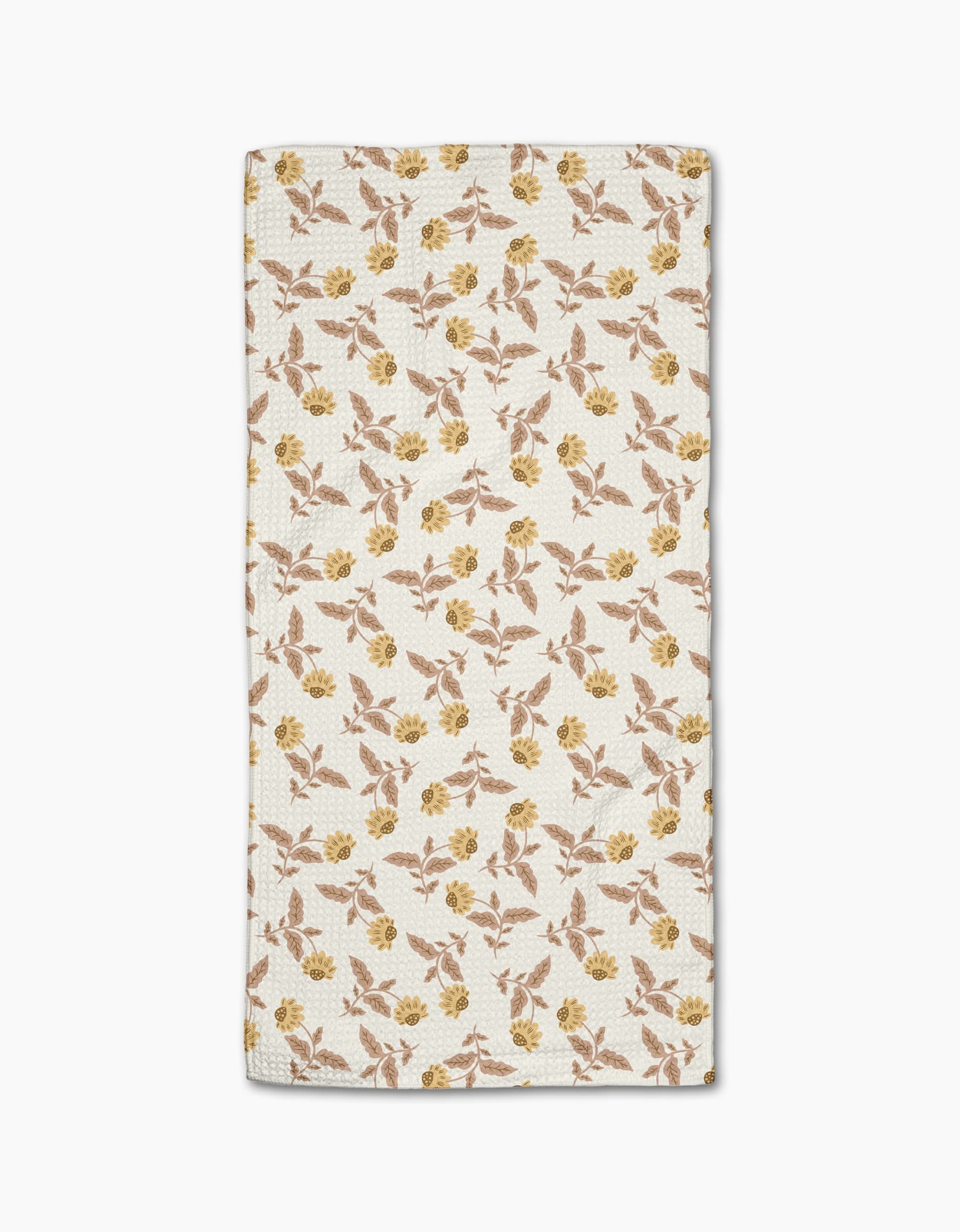The Wildflower Vine Honey Bar Towel by Danelys Sidron features a white rectangular design with small yellow and brown flowers and green leaves, made from ultra-absorbent Geoweave fabric, shown on a plain white background.