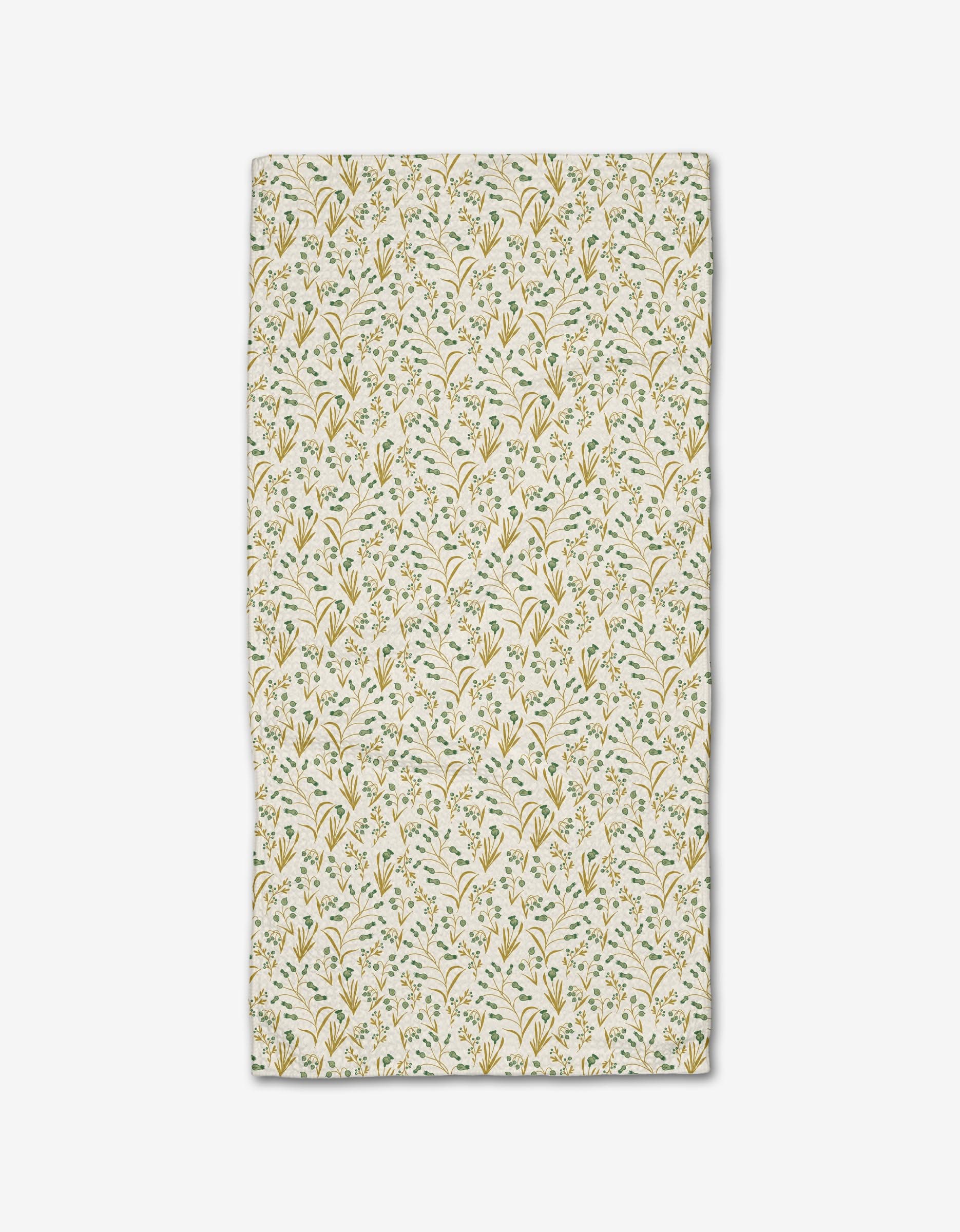 The Wildlight bar towel by Danelys Sidron features a delicate yellow and green floral and leaf pattern on white, crafted from recycled materials.