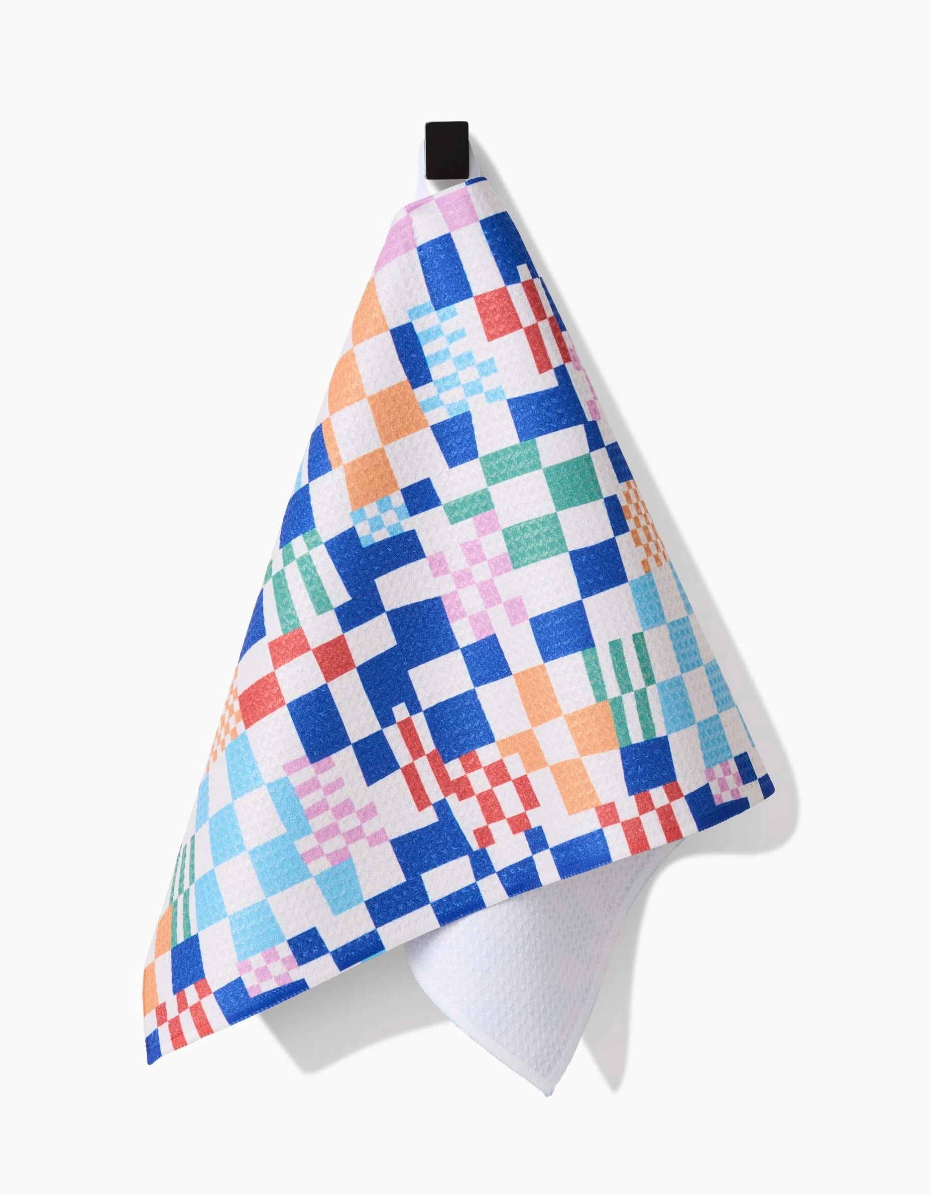 The Wonky Checkers bar towel by Claire Iglesias features a vibrant checkered design in blue, orange, red, green, and purple on Geoweave fabric with a black hanging loop, shown against a white background.