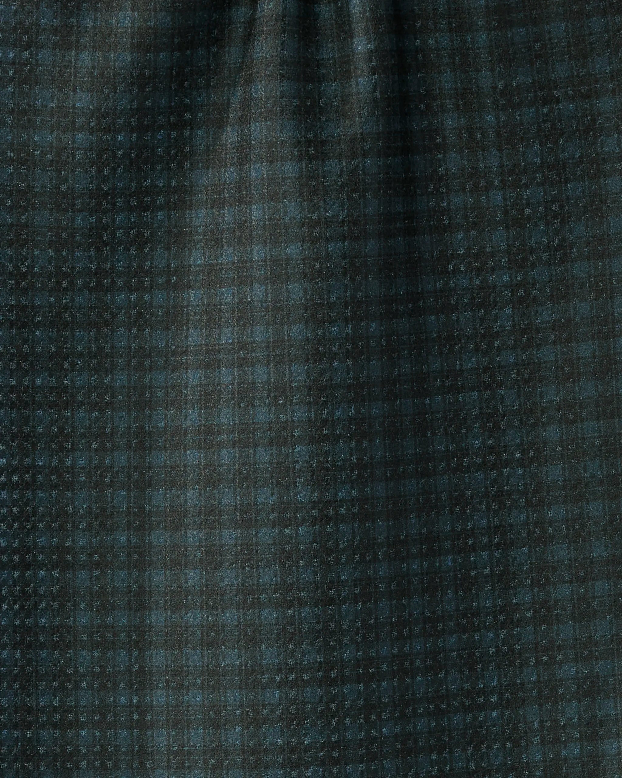 Close-up of Geometry's Wren fabric, featuring a dark green and black plaid with a subtle checked pattern and fine texture, resembling a recycled kitchen towel with soft folds and gentle light shading.