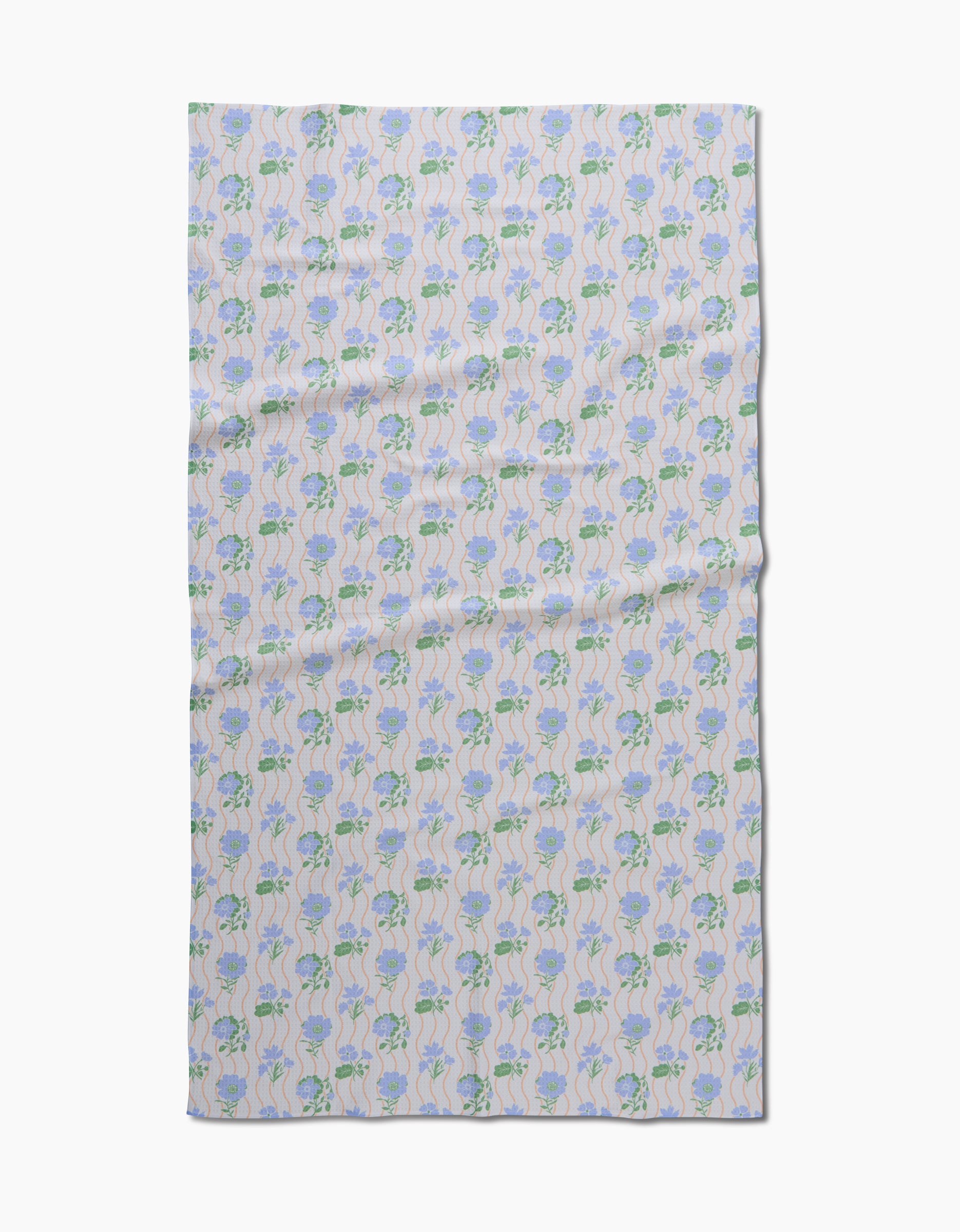 The Spring Wave blanket by Danelys Sidron features a symmetrical blue and green floral pattern on a pale background, made from post-consumer recycled materials.