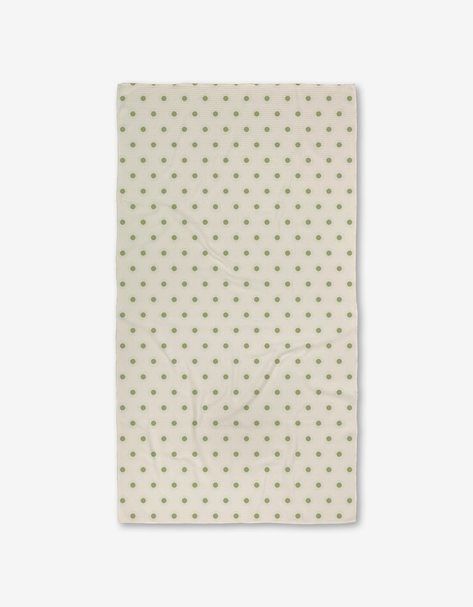 The Sunshine Glow by Danelys Sidron is a cream-colored rectangular cloth with evenly spaced green polka dots, made from recycled materials, displayed flat against a white background.