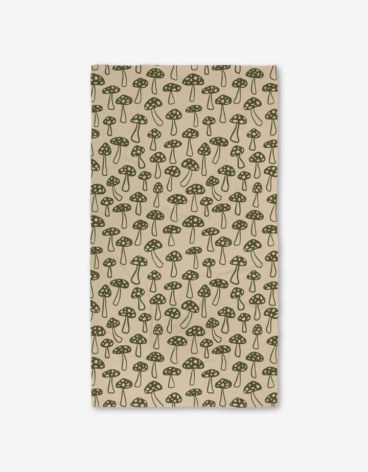The Woodland Mushroom by Kayla Ann is a beige rectangular cloth with a green dotted mushroom pattern, evenly spaced and made from ultra-absorbent recycled materials.