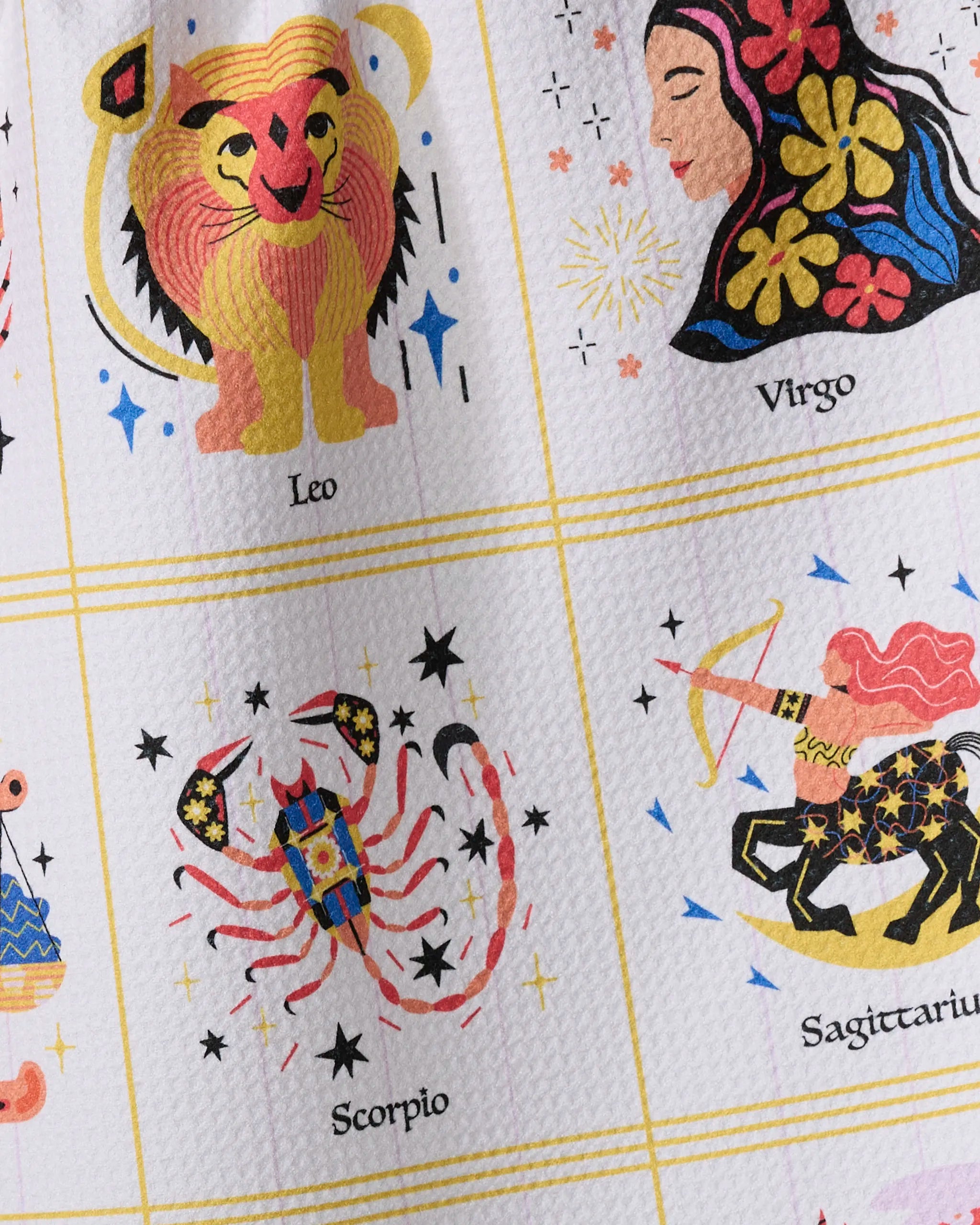 A close-up of Heather Zhou’s Cosmic Harmony tea towel, crafted from recycled materials and showcasing Leo, Virgo, Scorpio, and Sagittarius zodiac signs with stars and vibrant patterns.