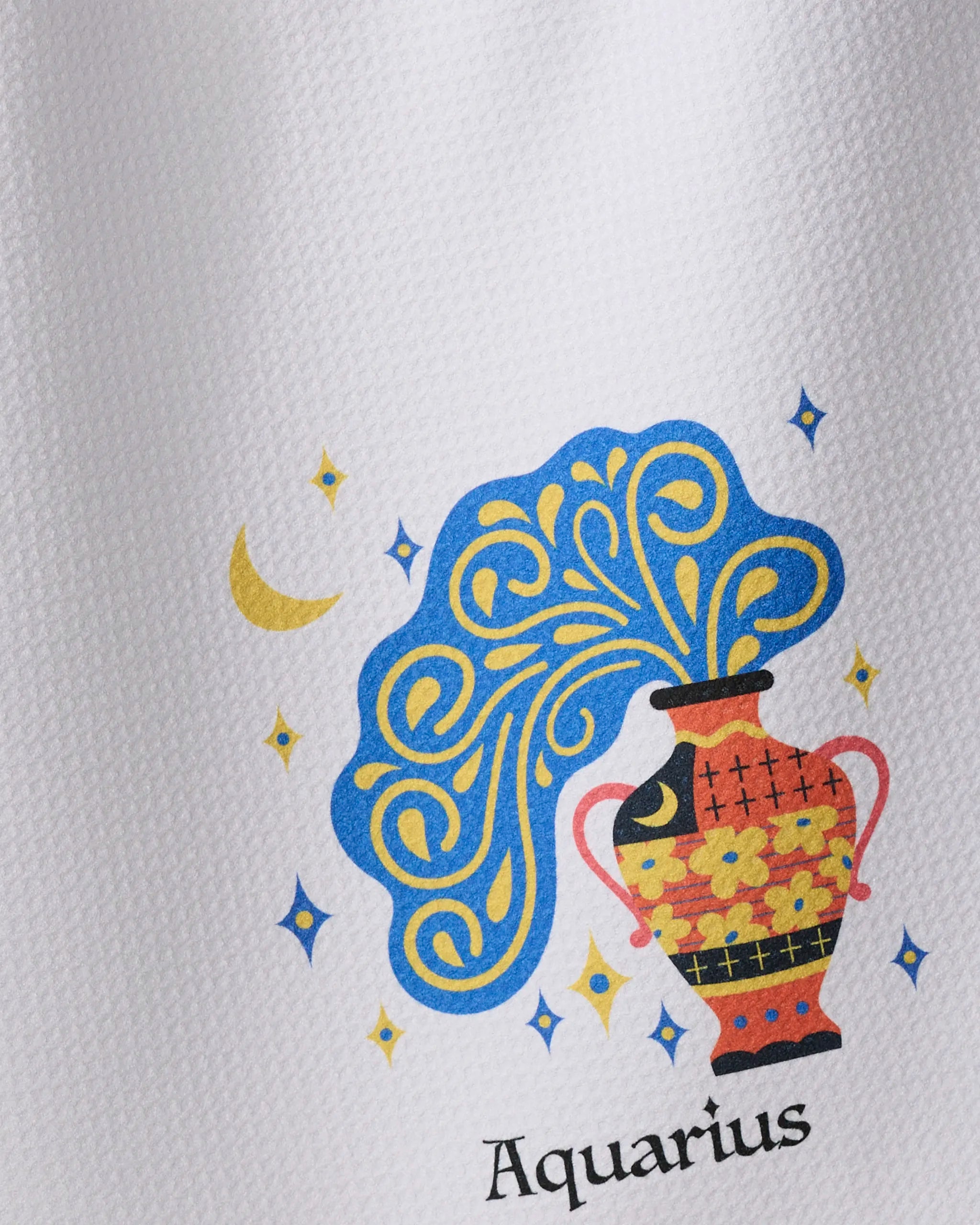 Free Aquarius by Heather Zhou is a decorative tea towel featuring a vase with swirling blue water, yellow stars, and a crescent moon above “Aquarius”—a zodiac-inspired design that’s ultra-absorbent and perfect for brightening any kitchen.