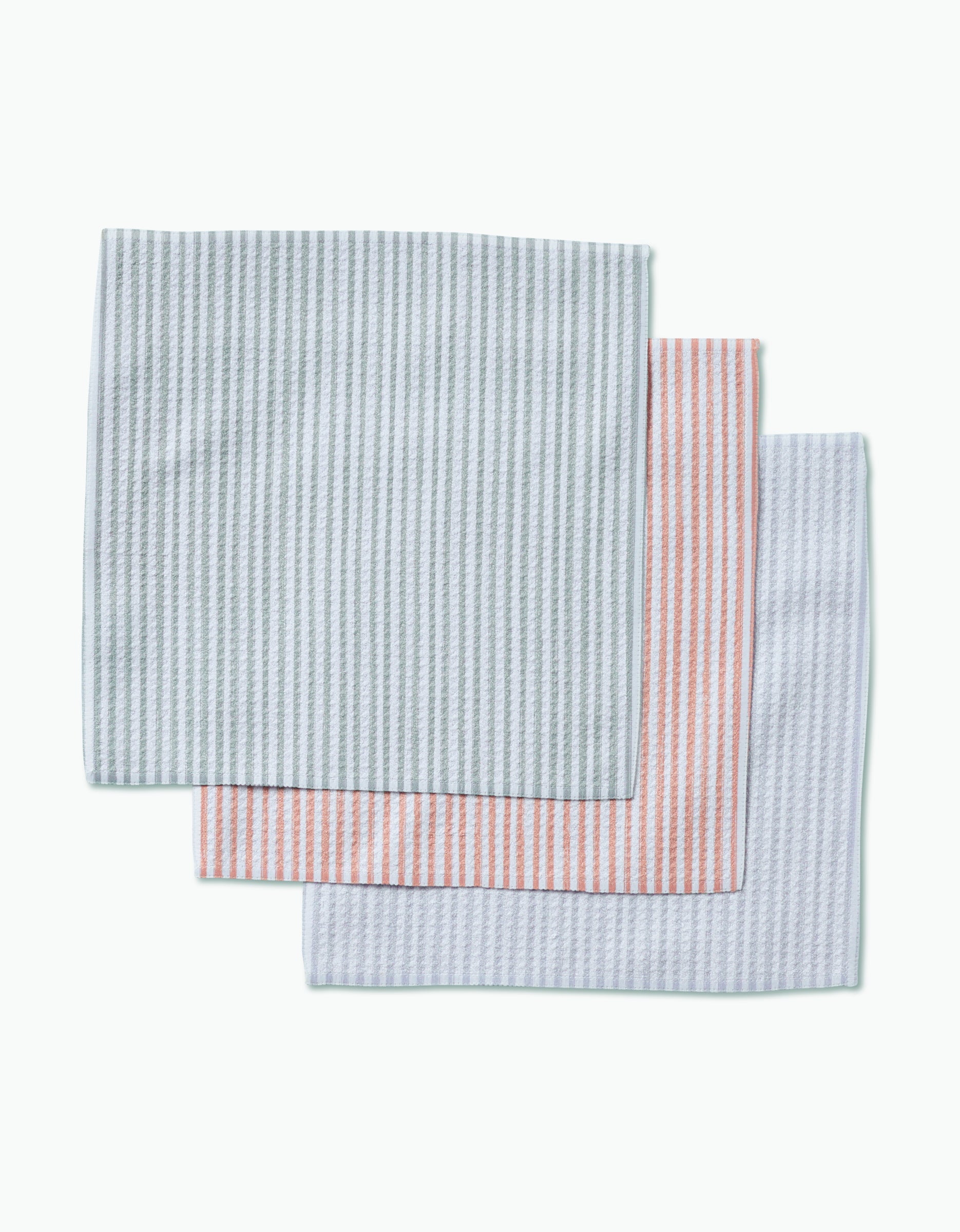 Three À La Carte dishcloths by Kailee Wright, featuring thin vertical stripes in light blue, pink, and gray, are neatly stacked on a white background. Each is crafted from recycled materials.