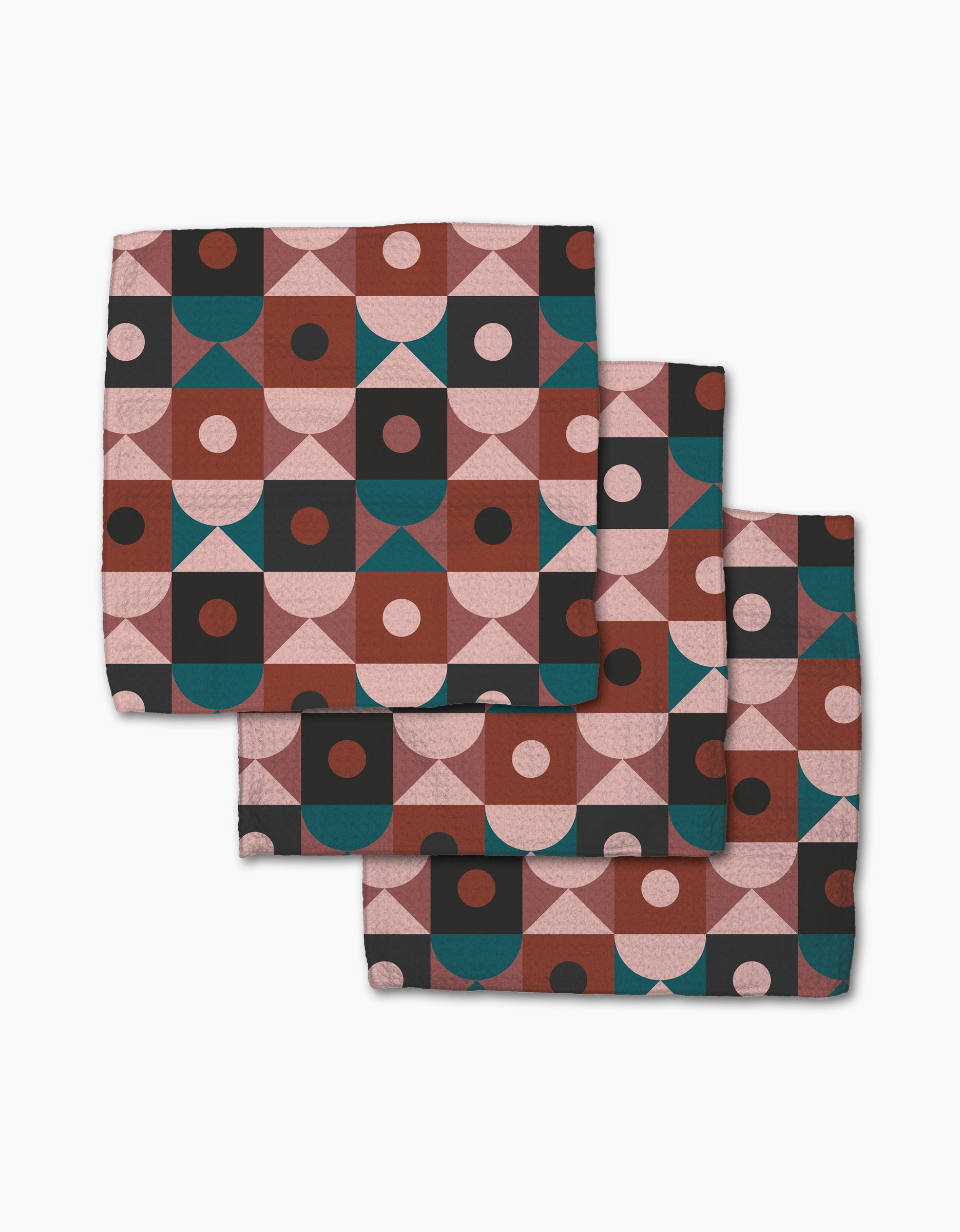 The Abstract Retro dishcloth set by Jennifer Bouron features three folded napkins with stylish geometric patterns—half circles, squares, and dots in pink, maroon, teal, and black on white—perfectly super-absorbent for your kitchen.
