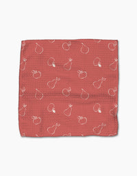 The Linda Fox “Apples and Pears” is a textured, square red cloth made from recycled materials, featuring an outlined apple and pear pattern scattered across its surface.