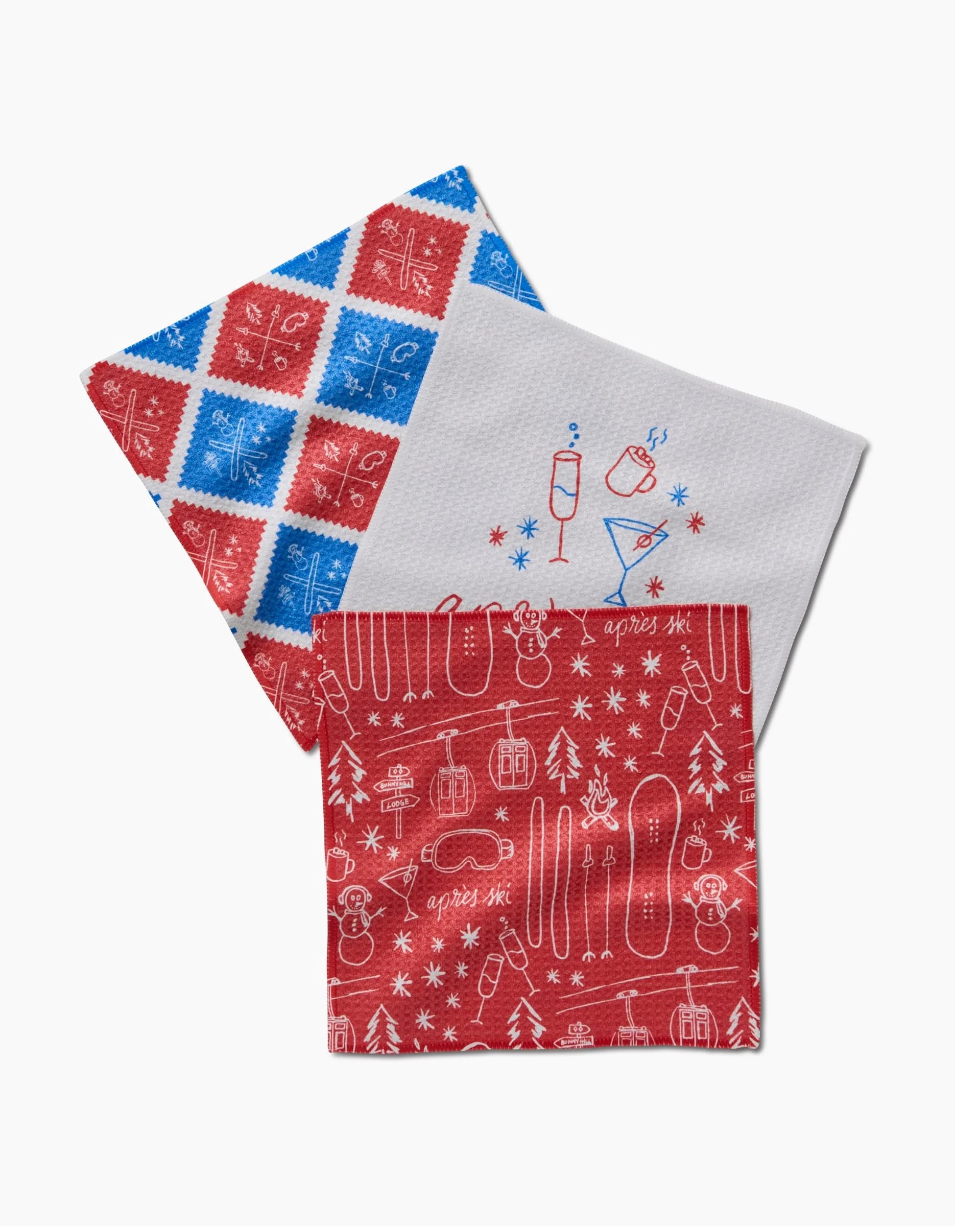 The Rosa Kichline Apres Ski set includes three kitchen tea towels: one with red and blue geometric Geoweave, one white with illustrated drinks, and one red with white winter sports and après-ski designs.
