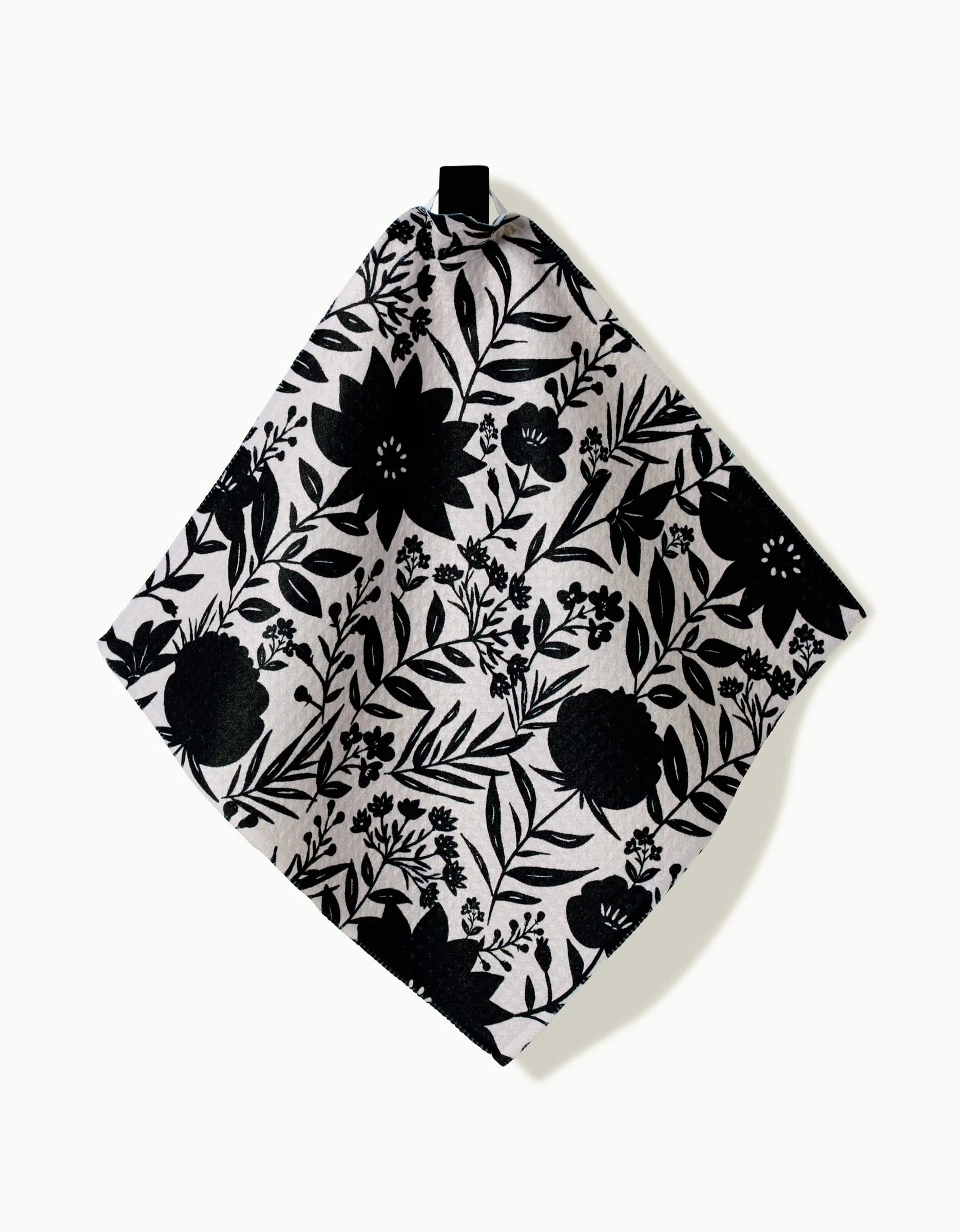 The Danelys Sidron Autumn Plaid is a square dishcloth crafted from Geoweave fabric, featuring an autumn plaid pattern on a light background and hanging from a black loop at one corner.
