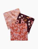 The Autumnal Reverie dishcloth set by Ashley Celena features three square napkins with autumn-inspired designs, crafted from recycled materials—ideal for adding seasonal charm to your kitchen.