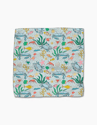 The Mindfulnice Beneath the Waves dishcloth set features a vibrant underwater pattern of fish, seaweed, starfish, shells, and coral on light blue. Made from recycled materials for an eco-friendly clean.