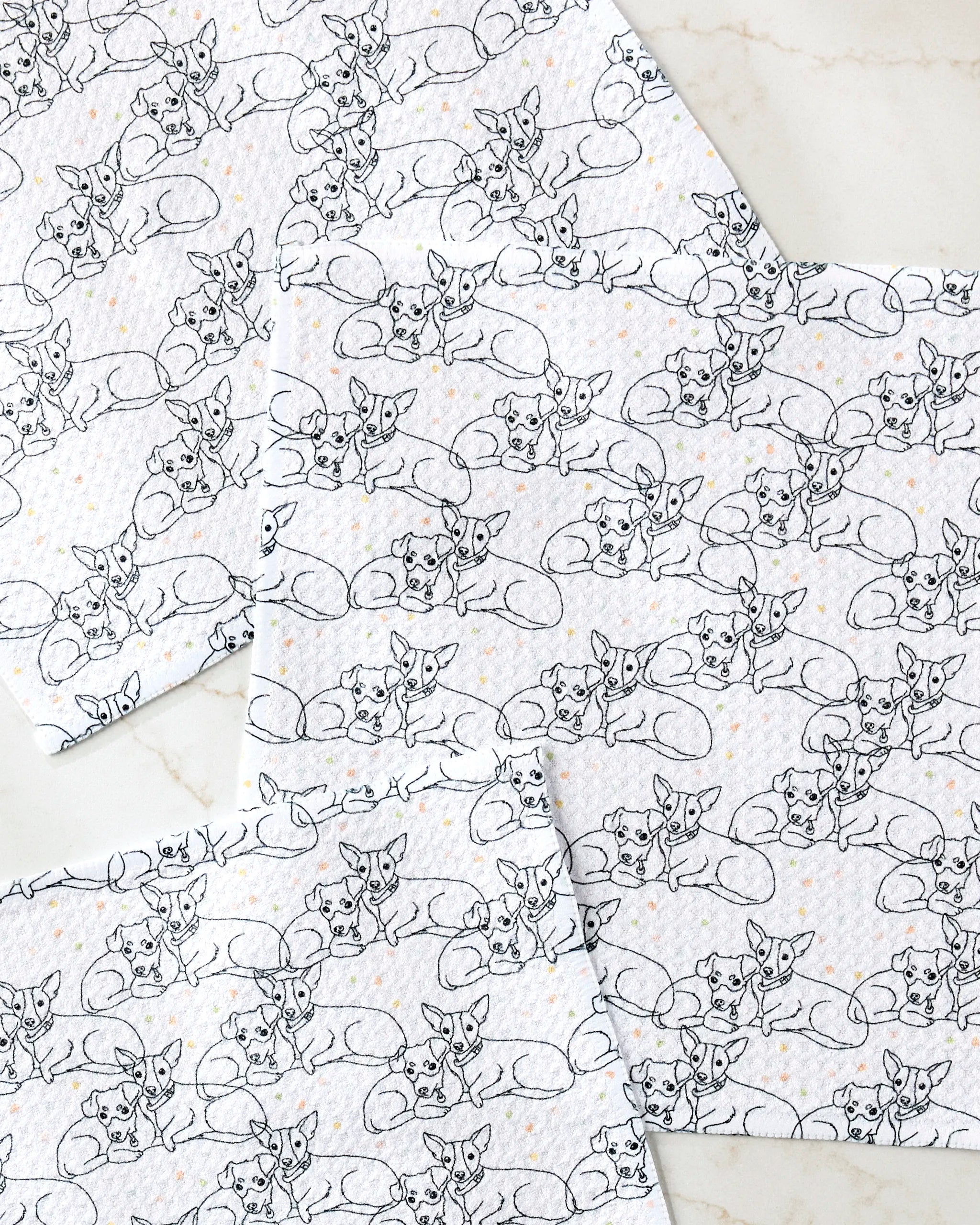 The Berry and Louie set by Sweet Simple Vegan includes four eco-friendly kitchen towels with black line fox patterns and orange dots, displayed on a light marble surface.