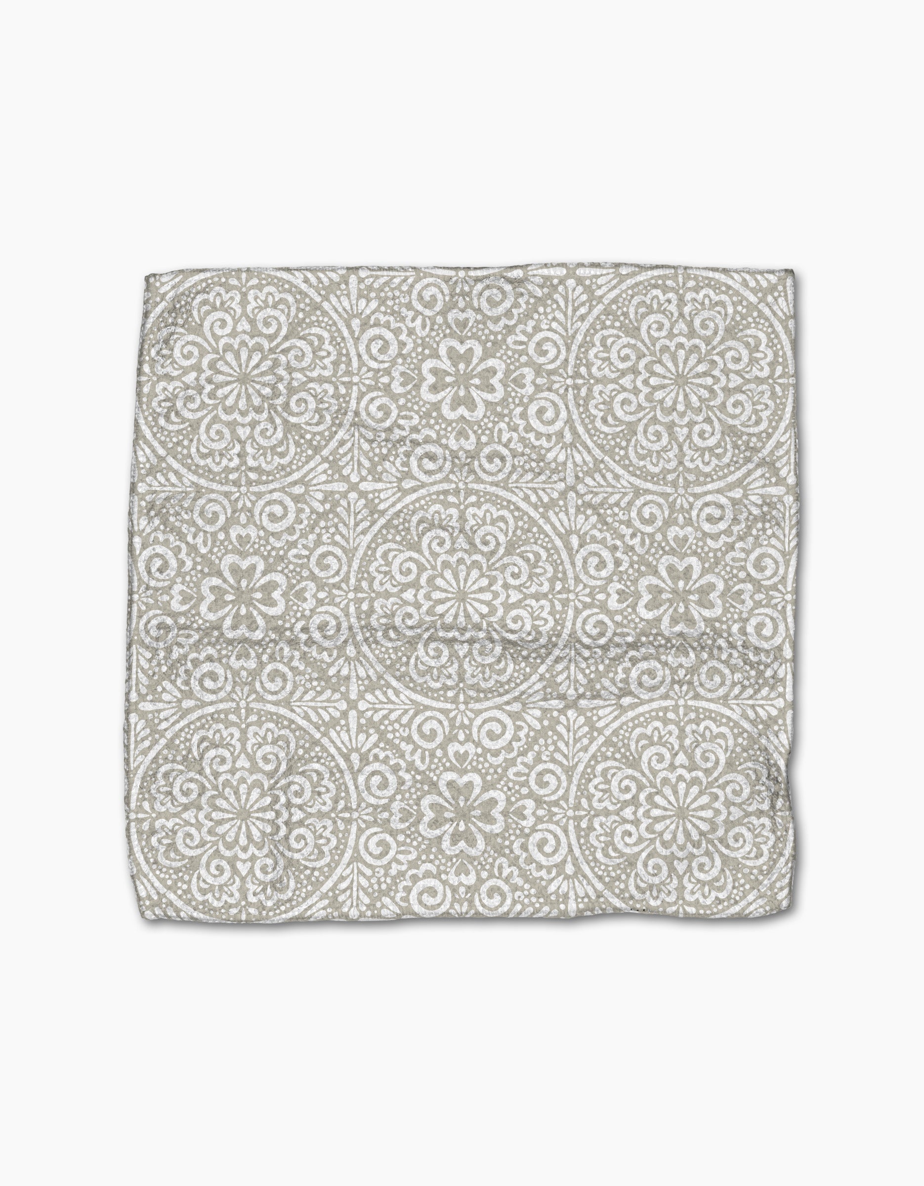 The Boho Medallion cloth napkin by Kris Ruff is crafted from Geoweave fabric and showcases a gray and white medallion pattern on a white background, displayed flat against a white surface.