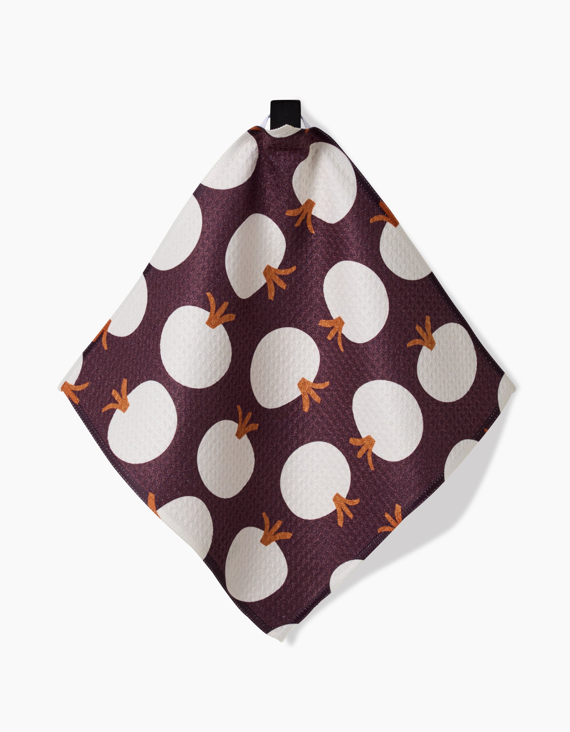The Bold Fall dish towel by Lizzie Clark features a dark purple background with large white circles and orange stems like stylized pumpkins. Fast-drying and square, it includes a small black hanging loop at the top.