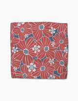 The Ashley Celena Botanical Blush square dishcloth set features large red flowers with white accents on a blue background, scattered with small white blooms, and is crafted from recycled materials for eco-friendly style.