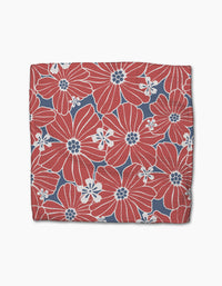 The Ashley Celena Botanical Blush square dishcloth set features large red flowers with white accents on a blue background, scattered with small white blooms, and is crafted from recycled materials for eco-friendly style.