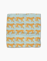 The Cheetah Haven dishcloth set by Jasmine Blooms Designs features light blue fabric with standing cheetahs in orange and black. Made from recycled materials, these super-absorbent towels bring style to any kitchen.