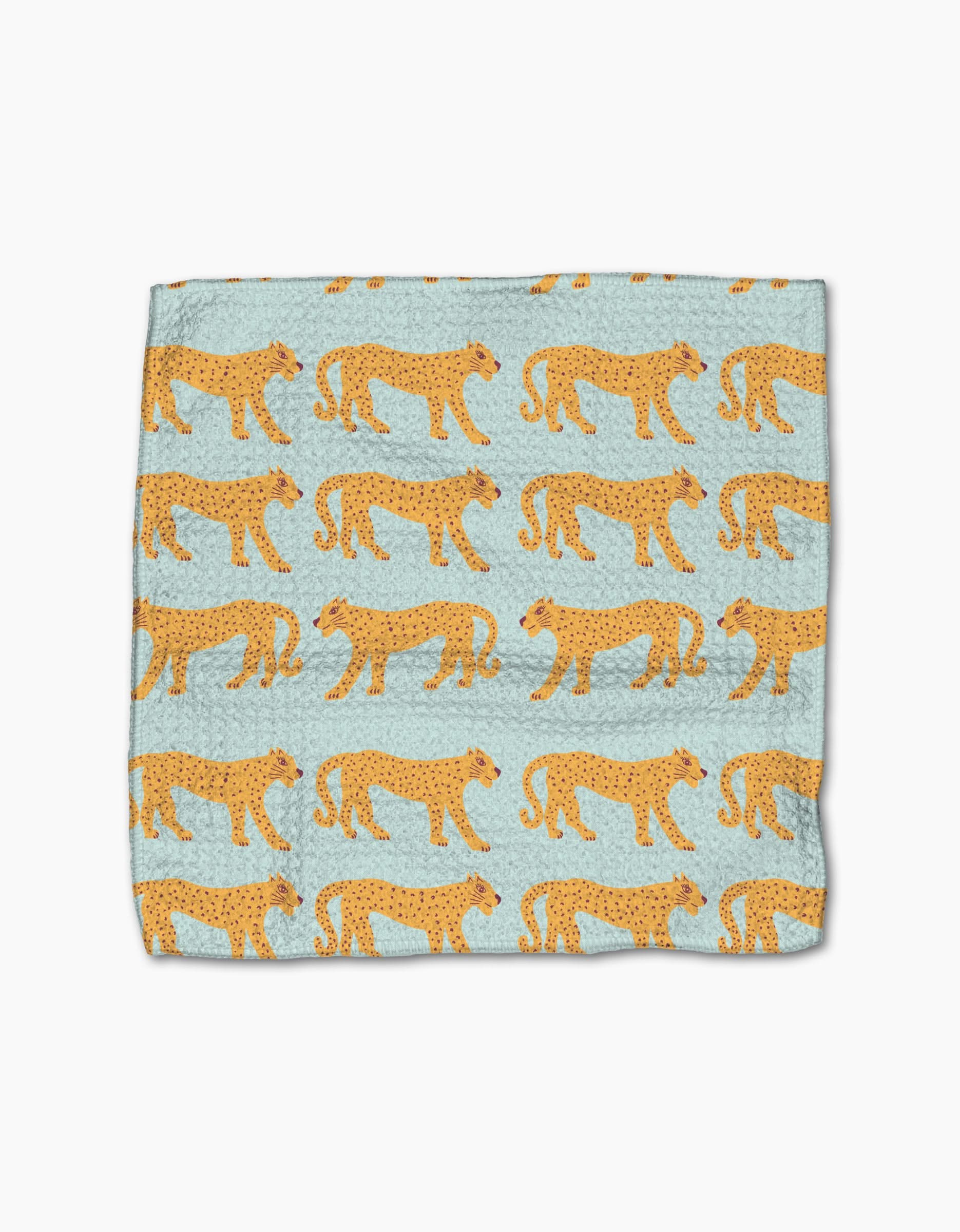 The Cheetah Haven dishcloth set by Jasmine Blooms Designs features light blue fabric with standing cheetahs in orange and black. Made from recycled materials, these super-absorbent towels bring style to any kitchen.