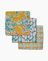 The Cheetah Haven dishcloth set by Jasmine Blooms Designs features three folded cloths with playful cheetah and floral prints, crafted from recycled materials for charming, eco-friendly style.