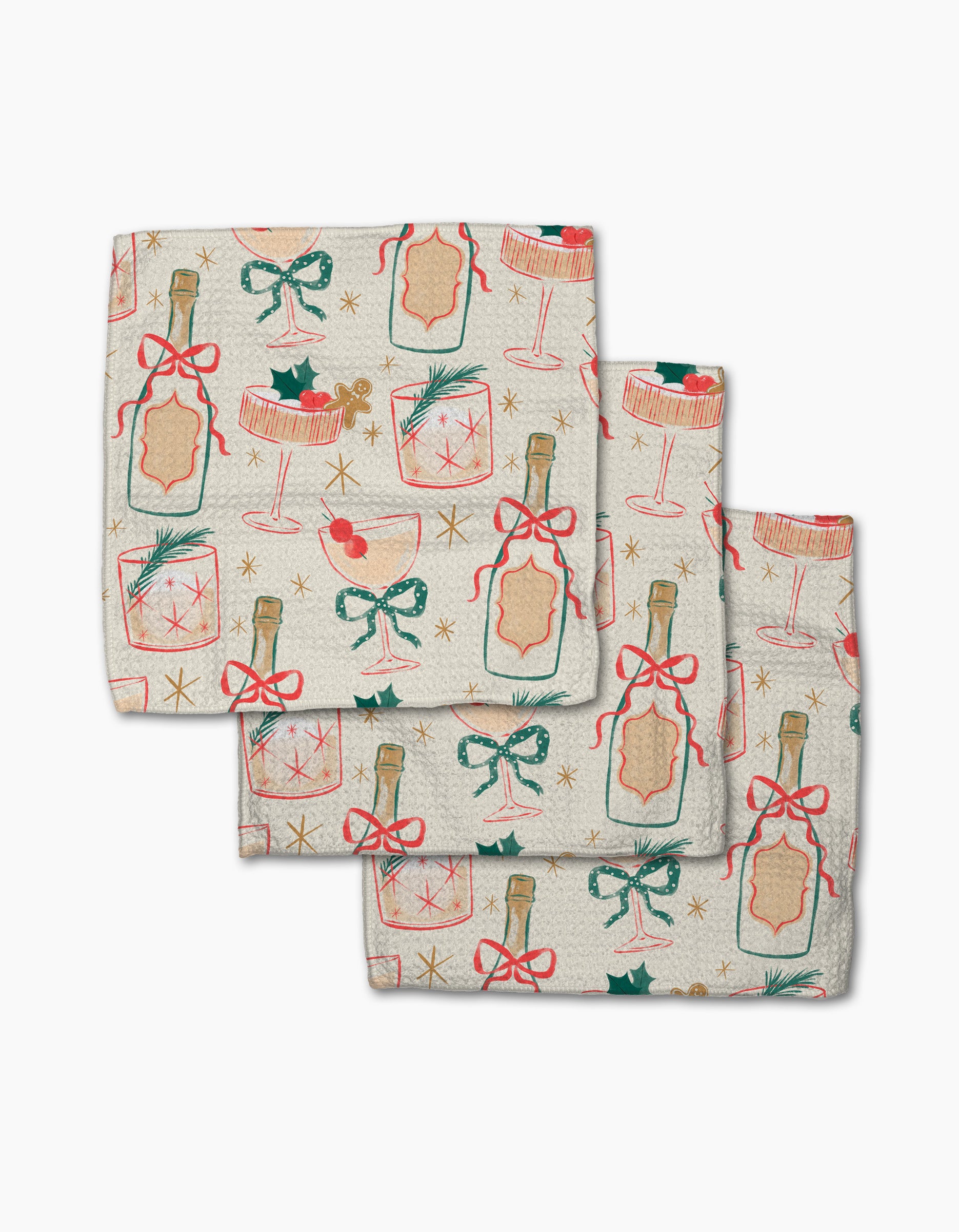 Set of three folded "Christmas Cocktails" cloth napkins by Louise Pretzel, featuring champagne bottles, cocktail glasses, holly, bows, and gold stars—an eco-friendly dishcloth set for your holiday kitchen.