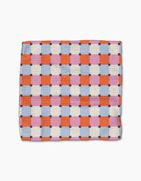 The Claire Iglesias Color Block Grid Dishcloth Set features a super-absorbent design with orange, pink, and blue squares outlined by white and small dark blue squares at the intersections on a white background.